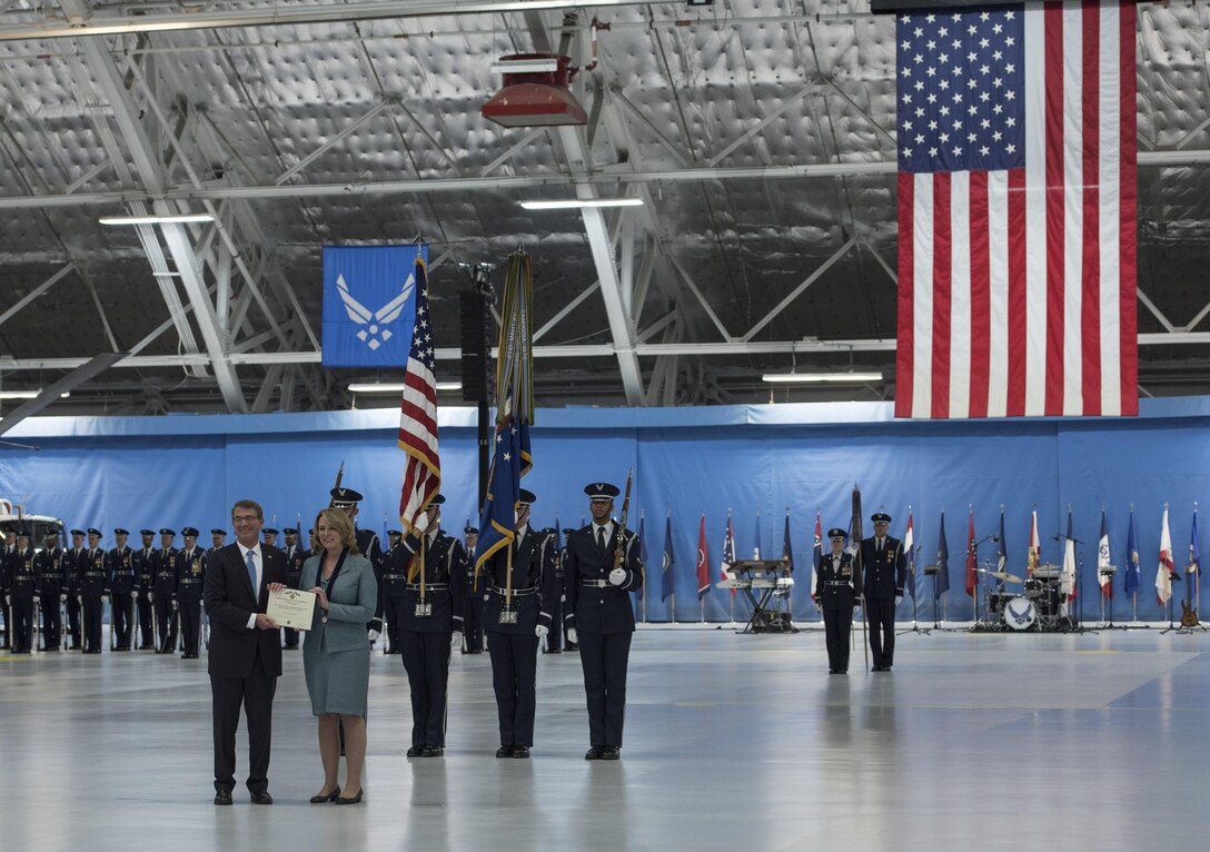Secretary of Defense Ash Carter presents Secretary of the Air Force Deborah Lee James with a certificate during her farewell ceremony at Joint Base Andrews, Md., Jan. 11, 2017. More than 200 Airmen belonging to the 11th Wing assisted in setting up bleachers, chairs and equipment as well as directing traffic and providing security. (U.S. Air Force photo by Senior Airman Jordyn Fetter)