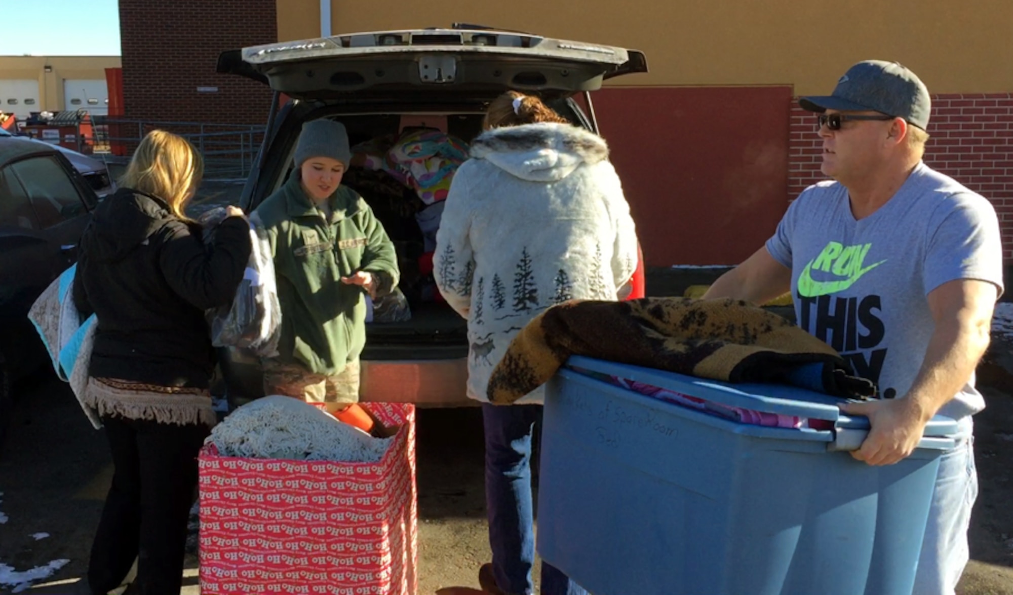 Volunteers from Ellsworth Air Force Base unload donated blankets at the Cornerstone Rescue Mission in Rapid City, S.D., Dec. 19, 2016.  Both the Hope Center and Cornerstone accept donations of many items such as food, clothing, blankets, baby products, and hygiene products for those in need. (Courtesy photo)