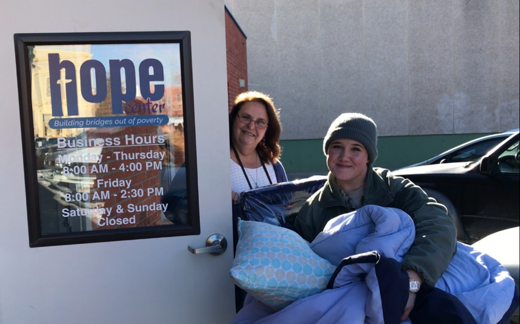 Airman 1st Class Katelin Offutt, a mental health technician assigned to the 28th Medical Group, delivers blankets to the Hope Center in Rapid City, S.D., Dec. 19, 2016. More than 100 blankets were donated to both the Hope Center and Cornerstone Rescue Mission to provide the homeless in the community covers for the winter. (Courtesy photo)