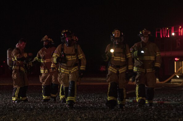 Firefighters from the 23rd Civil Engineer Squadron begin to congregate after completing nighttime, live-fire training, Jan. 10, 2017, at Moody Air Force Base, Ga. It’s required by the Federal Aviation Administration that every airfield have a firefighting team on standby in case of an aircraft incident. (U.S. Air Force photo by Airman 1st Class Daniel Snider)