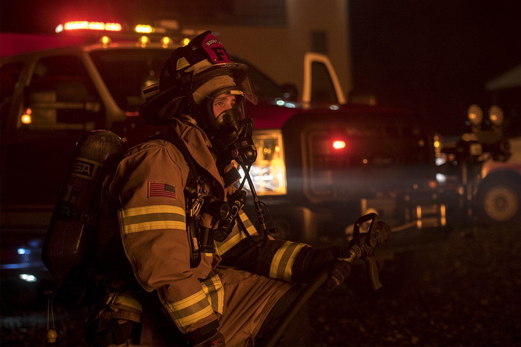 Staff Sgt. Joshua Humes, 23d Civil Engineer Squadron fire protection crew chief, kneels during nighttime, live-fire training, Jan. 10, 2017, at Moody Air Force Base, Ga. Approximately 15 firefighters participated in this live fire training. (U.S. Air Force photo by Airman 1st Class Daniel Snider)