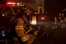 Staff Sgt. Joshua Humes, 23d Civil Engineer Squadron fire protection crew chief, kneels during nighttime, live-fire training, Jan. 10, 2017, at Moody Air Force Base, Ga. Approximately 15 firefighters participated in this live fire training. (U.S. Air Force photo by Airman 1st Class Daniel Snider)