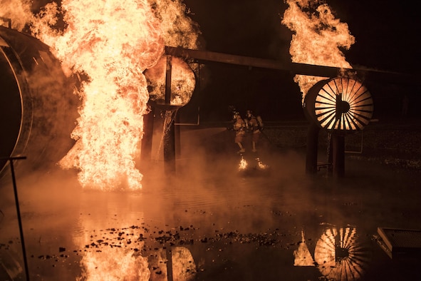 Firefighters from the 23d Civil Engineer Squadron douse flames during nighttime, live-fire training, Jan. 10, 2017, at Moody Air Force Base, Ga. All of Moody’s firefighters are required to perform this training at least once a year. (U.S. Air Force photo by Airman 1st Class Daniel Snider)