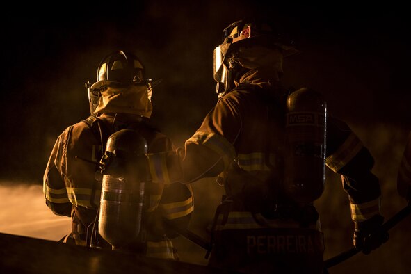Matthew Perreira (right), 23rd Civil Engineer Squadron firefighter, backs up a fellow firefighter during nighttime, live-fire training, Jan. 10, 2017, at Moody Air Force Base, Ga. This training is an annual requirement for Moody firefighters and is just one of the ways they stay ready to protect people, property and the environment from fires and disasters. (U.S. Air Force photo by Staff Sgt. Ryan Callaghan)
