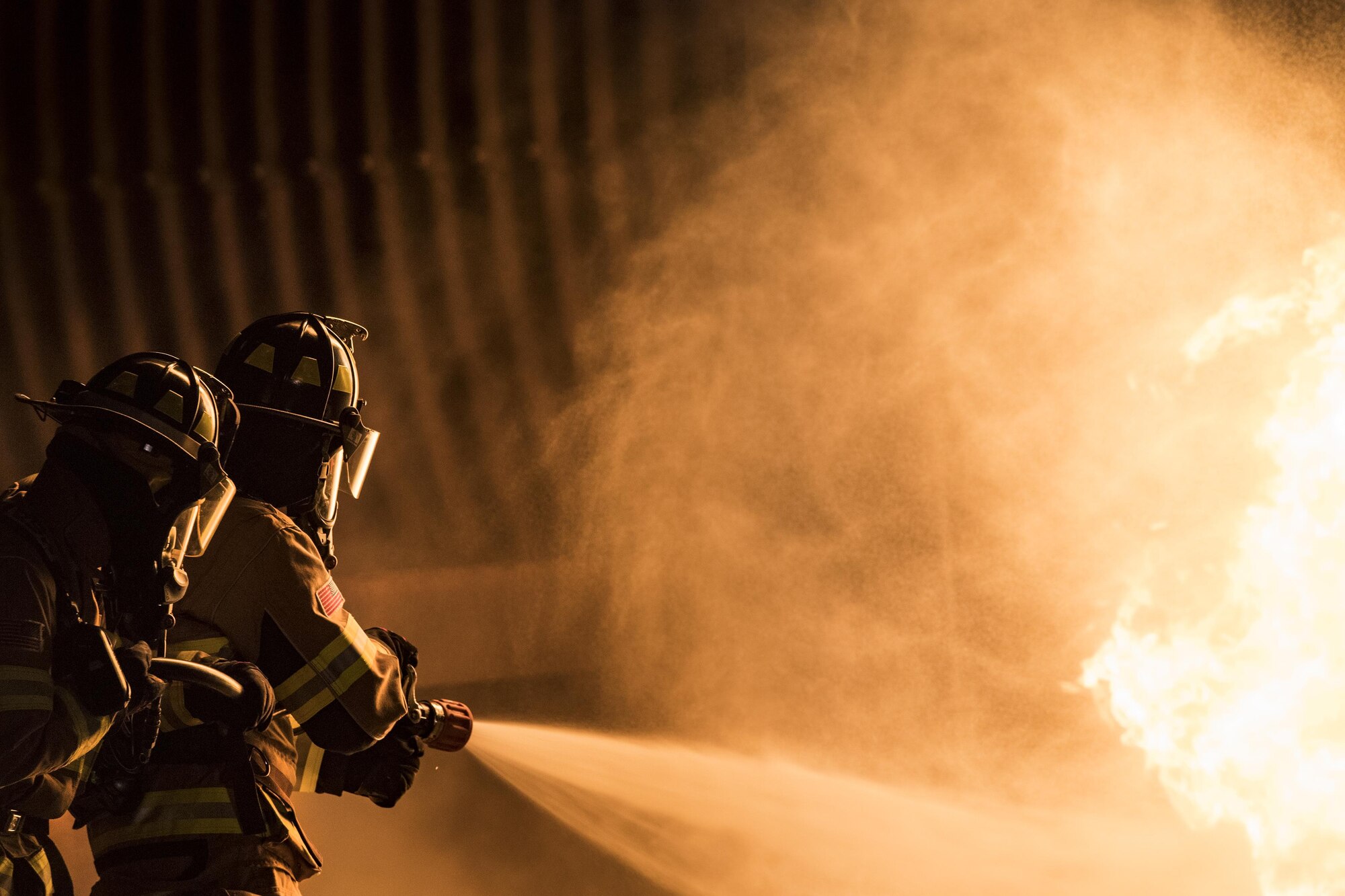 Firefighters from the 23d Civil Engineer Squadron extinguish a flame during nighttime, live-fire training, Jan. 10, 2017, at Moody Air Force Base, Ga. This training is an annual requirement for Moody firefighters and is just one of the ways they stay ready to protect people, property and the environment from fires and disasters. (U.S. Air Force photo by Staff Sgt. Ryan Callaghan)
