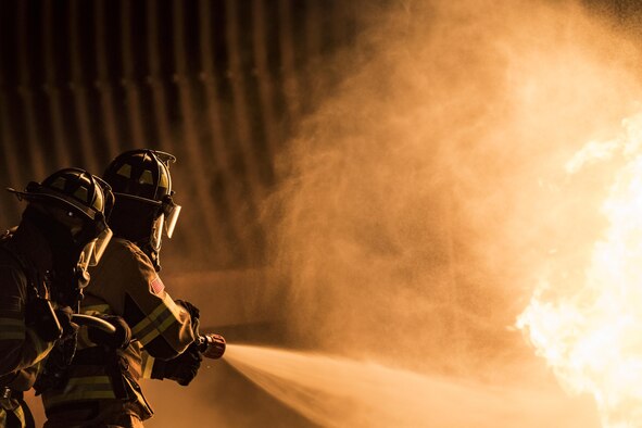 Firefighters from the 23rd Civil Engineer Squadron extinguish a flame during nighttime, live-fire training, Jan. 10, 2017, at Moody Air Force Base, Ga. This training is an annual requirement for Moody firefighters and is just one of the ways they stay ready to protect people, property and the environment from fires and disasters. (U.S. Air Force photo by Staff Sgt. Ryan Callaghan)
