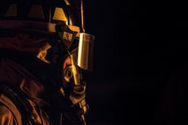 Airman 1st Class Jacob Molden, 23d Civil Engineer Squadron firefighter, looks towards a burning prop aircraft during nighttime, live-fire training, Jan. 10, 2017, at Moody Air Force Base, Ga. This training is an annual requirement for Moody firefighters and is just one of the ways they stay ready to protect people, property and the environment from fires and disasters. (U.S. Air Force photo by Staff Sgt. Ryan Callaghan)
