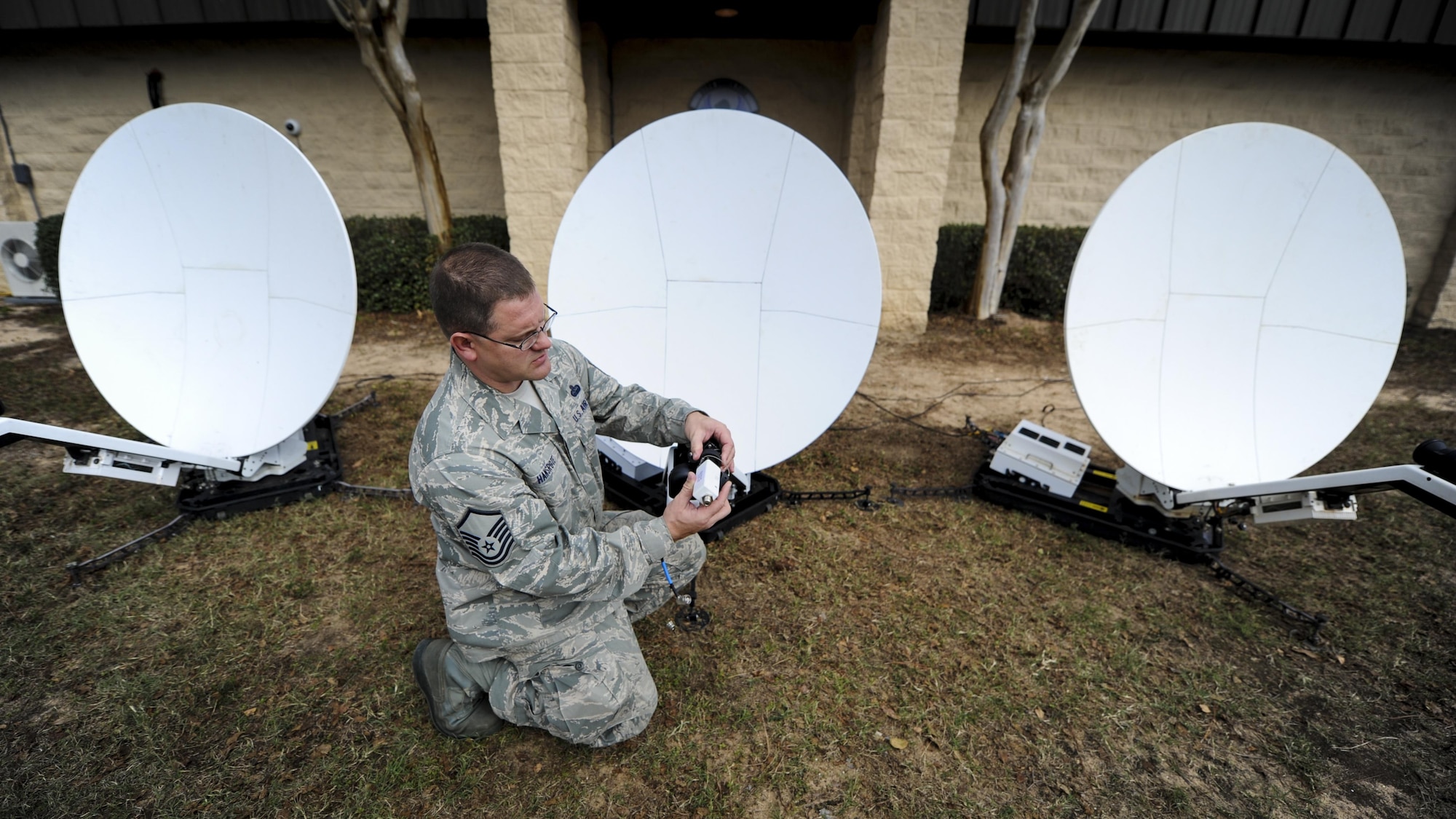 Master Sgt. Lucas Hansrote, chief of communications support with the 25th Intelligence Squadron, installs a soft deployable node terminal Hawkeye satellite dish at Hurlburt Field, Fla., Jan. 11, 2017. These dishes are used to provide secured internet access in deployed locations to continue special operations missions. Anytime, anyplace. (U.S. Air Force photo by Airman Dennis Spain)