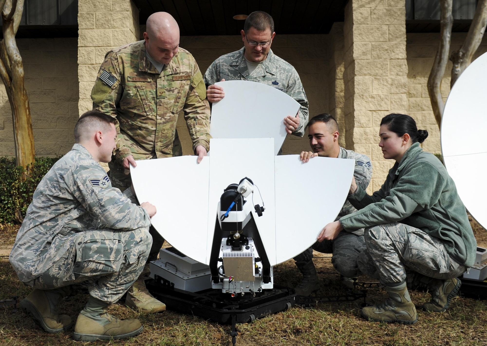 Members of the 25th Intelligence Squadron assemble a Hawkeye lite satellite dish at Hurlburt Field, Fla., Jan. 11, 2017. The satellite dishes are part of the special operations deployable node Silent Dagger. Silent Dagger provides classified network reach-back for intelligence support to Air Force Special Operations Command’s SILENT SHIELD mission. (U.S. Air Force photo by Airman Dennis Spain)