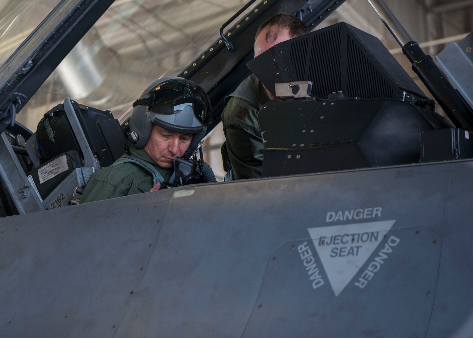 Brig. Gen. Eric Sanchez, the Commanding General at White Sands Missile Range, receives instruction from Maj. Brent Ellis, a fighter pilot with the 311th Fighter Squadron, prior to a familiarization flight in an F-16 Fighting Falcon, at Holloman Air Force Base, N.M., on Jan 9, 2017. Sanchez was offered a flight in an F-16 Fighting Falcon to gain a better understanding of the aircraft’s mission and its capabilities. (U.S. Air Force photo by Airman 1st Class Alexis P. Docherty)