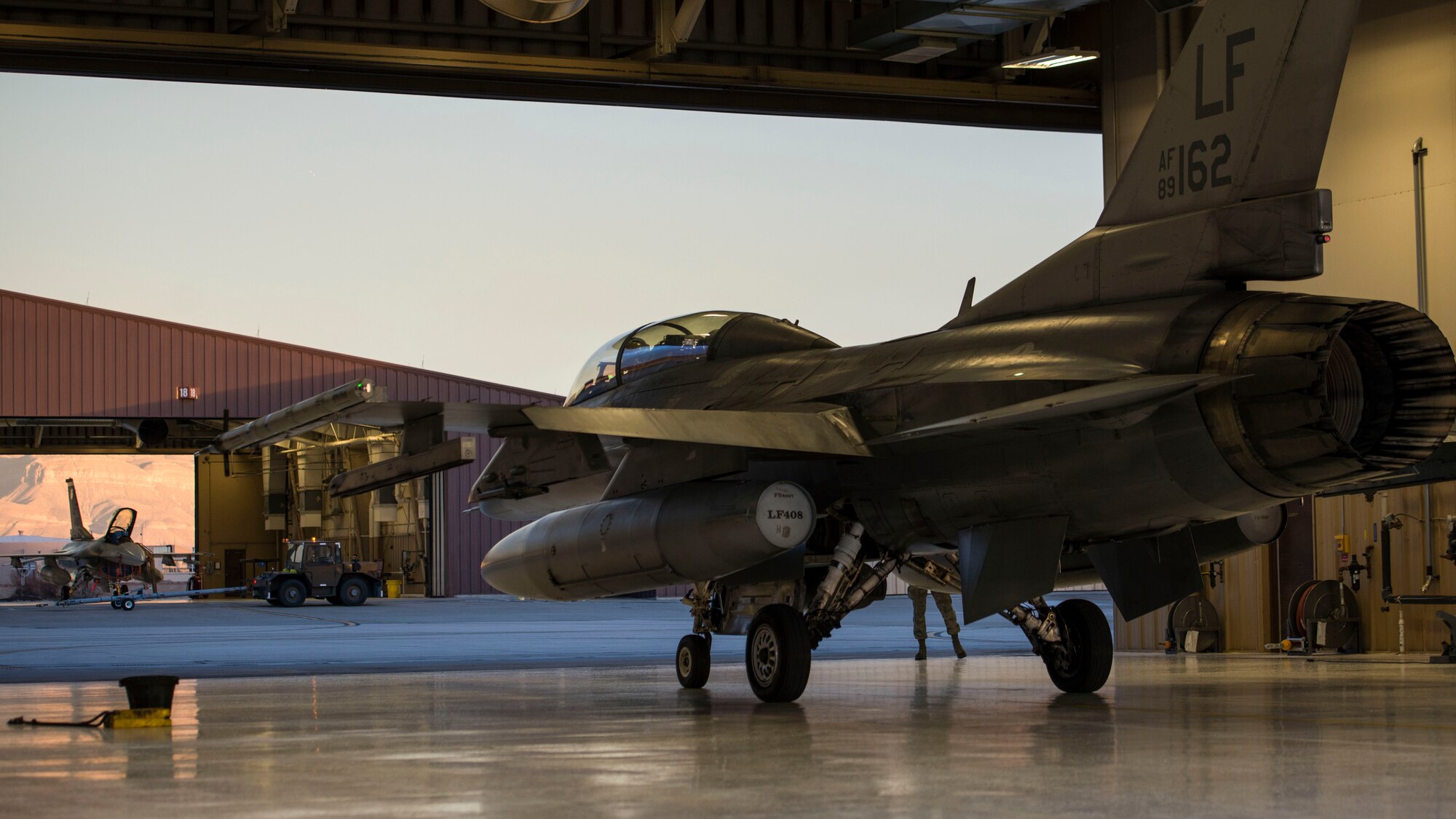 An F-16 Fighting Falcon piloted by Maj. Brent Ellis, a fighter pilot with the 311th Fighter Squadron, prepares to exit a hangar, at Holloman Air Force Base, N.M., on Jan. 9, 2017. Ellis flew Brig. Gen. Eric Sanchez, the Commanding General at White Sands Missile Range, on a familiarization flight to demonstrate Holloman’s F-16 mission and the aircraft’s capabilities. Sanchez visited Holloman AFB to attend an airspace and mission brief related to Holloman and WSMR’s ongoing partnership. (U.S. Air Force photo by Airman 1st Class Alexis P. Docherty)