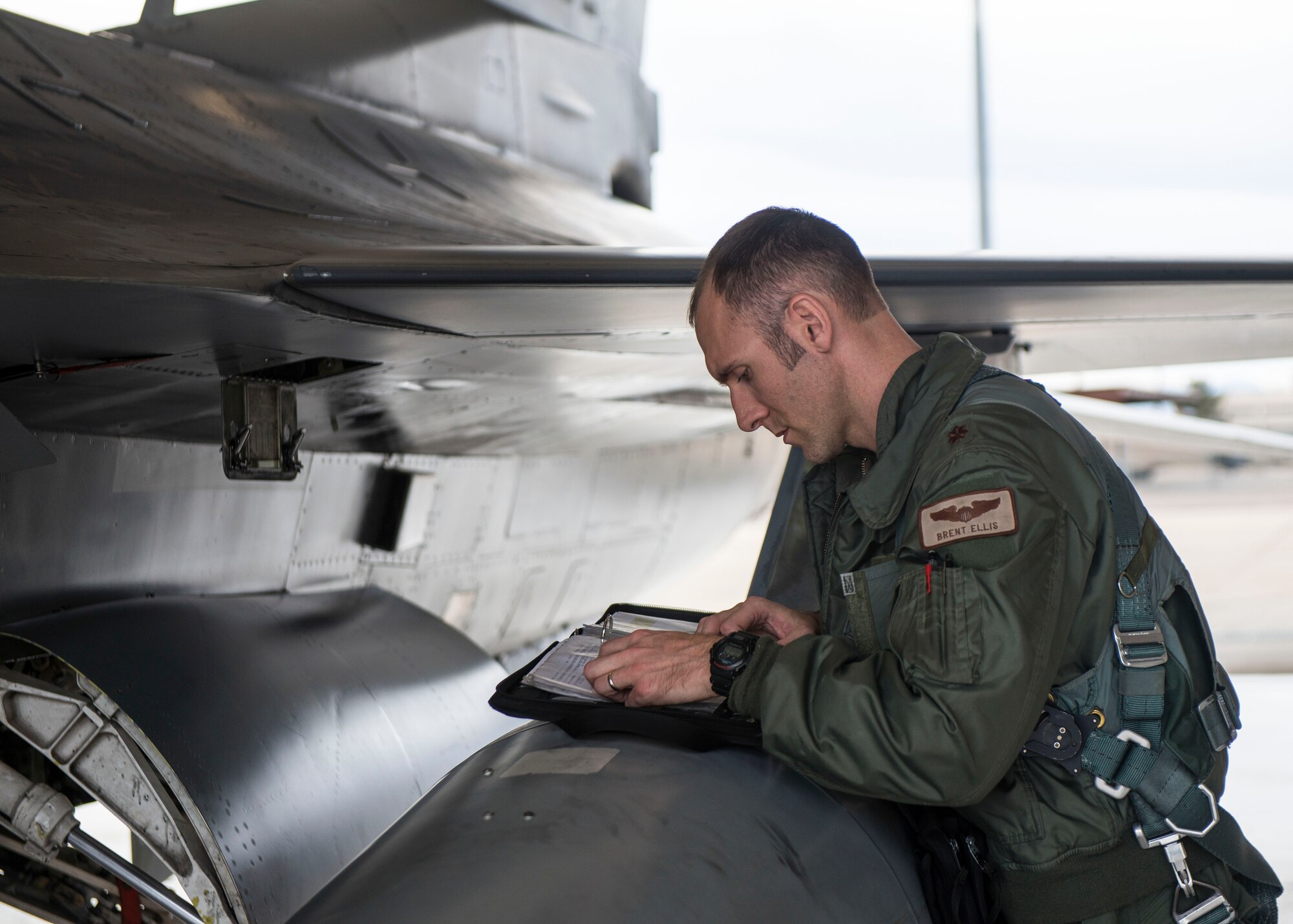 Maj. Brent Ellis, a fighter pilot with the 311th Fighter Squadron, performs pre-flight checks prior to executing a familiarization flight with Brig. Gen. Eric Sanchez, the Commanding General at White Sands Missile Range, at Holloman Air Force Base, N.M., on Jan. 9, 2017. Sanchez was offered a flight in an F-16 Fighting Falcon to gain a better understanding of the aircraft’s mission and its capabilities. (U.S. Air Force photo by Airman 1st Class Alexis P. Docherty)