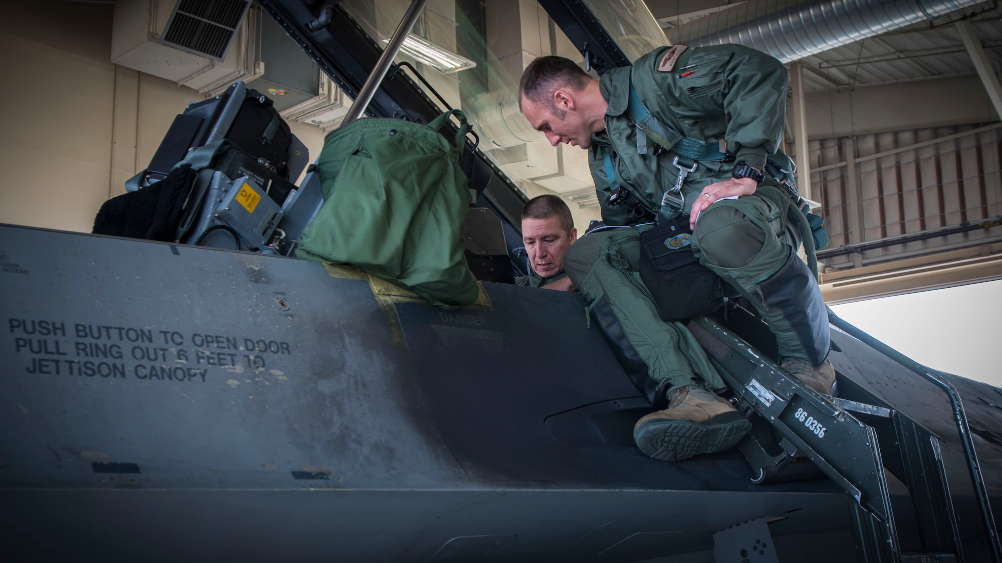 Maj. Brent Ellis, a fighter pilot with the 311th Fighter Squadron, instructs Brig. Gen. Eric Sanchez, the Commanding General at White Sands Missile Range, on basic flight procedures prior to a familiarization flight in an F-16 Fighting Falcon, at Holloman Air Force Base, N.M., on Jan. 9, 2017. Sanchez visited Holloman AFB to attend an airspace and mission brief related to Holloman and WSMR’s ongoing partnership. Sanchez was offered a flight in an F-16 Fighting Falcon to gain a better understanding of the aircraft’s mission and its capabilities. (U.S. Air Force photo by Airman 1st Class Alexis P. Docherty)