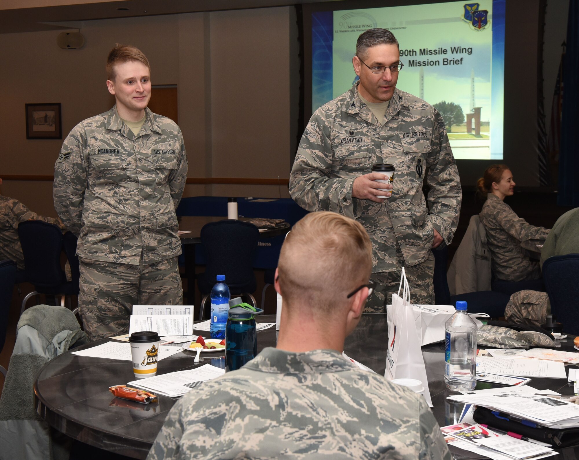 Col. Stephen Kravitsky, 90th Missile Wing commander, and Airman 1st Class Joseph McAndrew, 90th Logistics Readiness Squadron traffic management technician, socialize with new personnel during Right Start at F.E. Warren Air Force Base, Wyo., Jan. 11, 2017. McAndrew had the opportunity to spend a day with the wing commander to experience what a typical day is like for him. (U.S. Air Force photo by Airman 1st Class Breanna Carter)