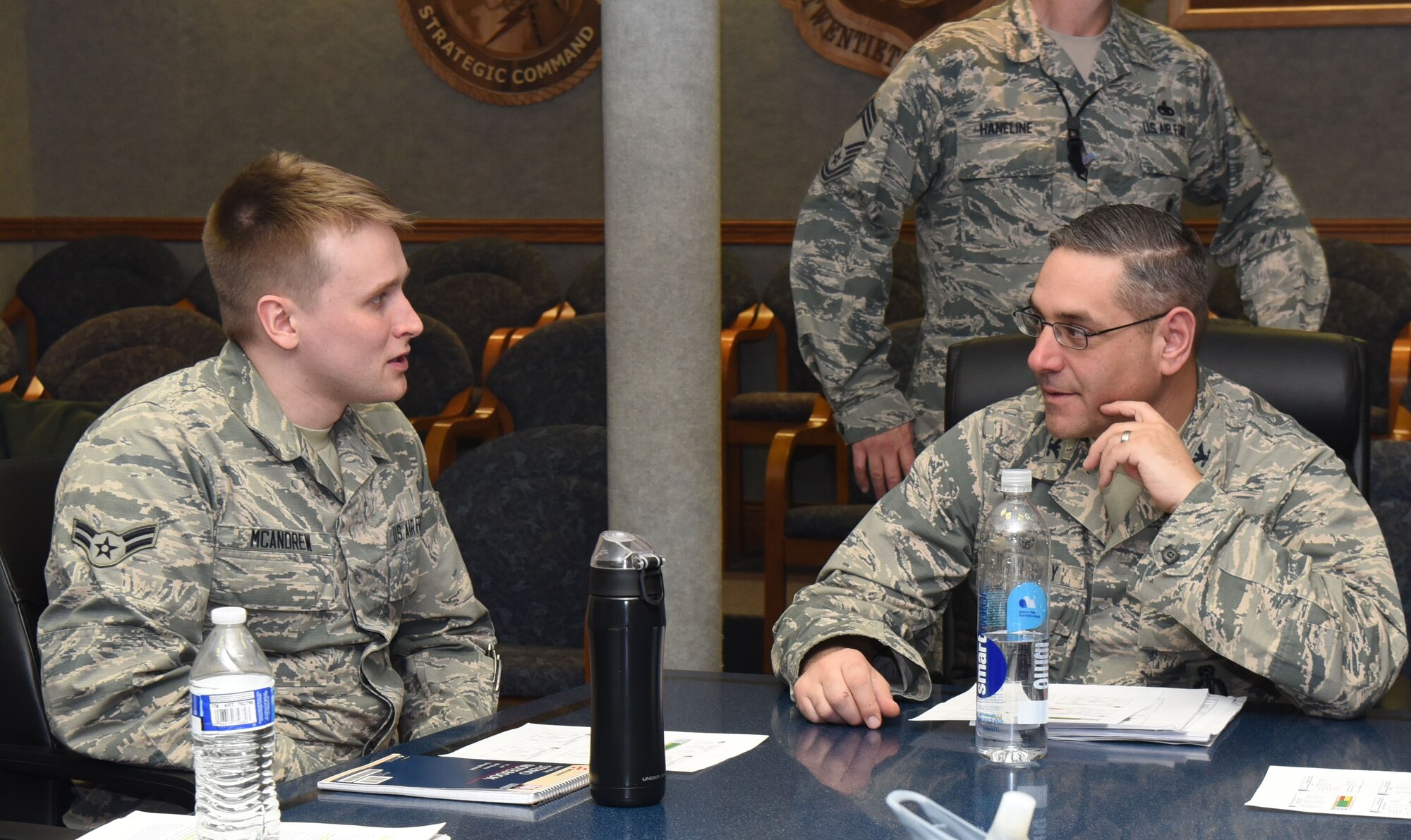 Col. Stephen Kravitsky, 90th Missile Wing commander, talks to Airman 1st Class Joseph McAndrew, 90th Logistics Readiness Squadron traffic management technician, after a meeting in the wing conference room at F.E. Warren Air Force Base, Wyo., Jan. 11, 2017. Attending this meeting and shadowing Kravitsky for the day gave McAndrew insight into how the wing operates. (U.S. Air Force photo by Airman 1st Class Breanna Carter)