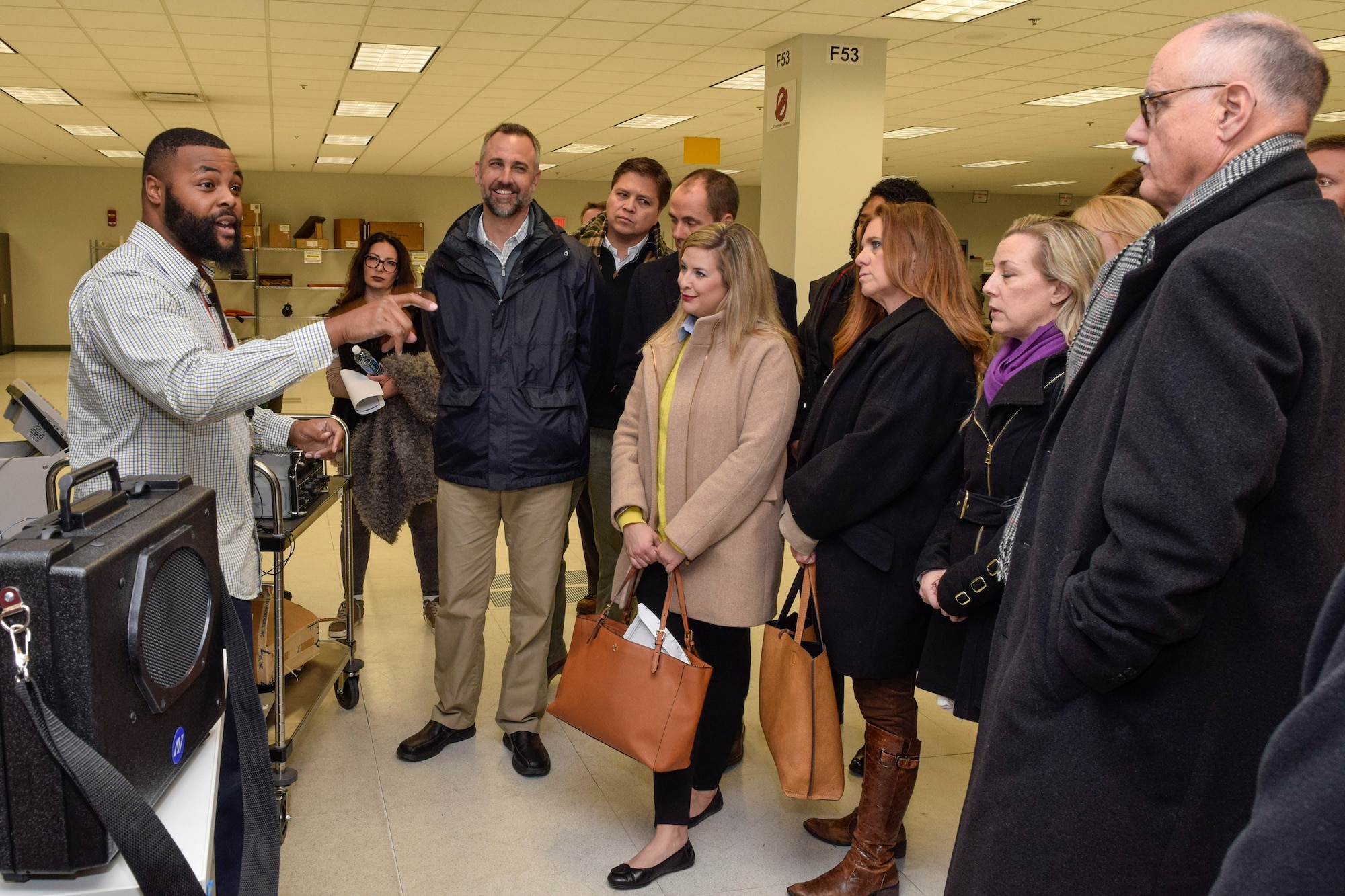 Durrell Hodge, left, 76th Software Maintenance Group software engineer, explains how his organization supports test program sets; the software/hardware and documentation that allows for the repair of avionics items in-house, to members of the Leadership Oklahoma group during a tour of the  Oklahoma City Air Logistics Complex and Tinker Air Force Base Jan. 5, 2017. Leadership Oklahoma allows key civic leaders from across the state to learn about the capabilities and importance of military installations within Oklahoma and to interface with key military leaders to build partnerships and mutual understanding. (U.S. Air Force photo/Greg L. Davis)