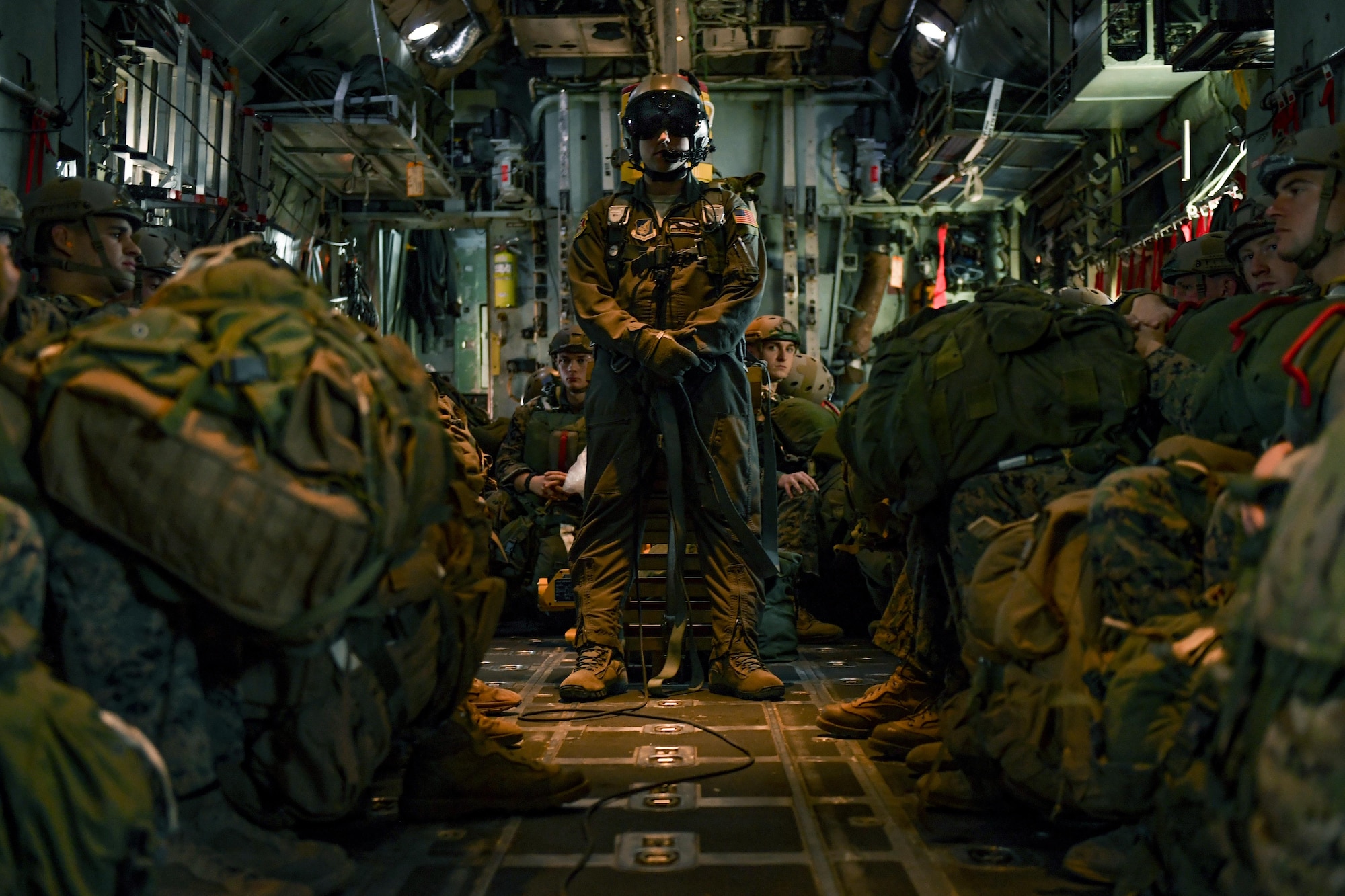Staff Sgt. Benjamin J. Shest, 36th Airlift Squadron loadmaster, and Marines with the 3rd Reconnaissance Battalion, 3rd Marine Division, III Marine Expeditionary Force, wait in a C-130 Hercules before a static line parachute drop on Jan. 11, 2017, at Yokota Air Base, Japan. The Marines work with the 36th Airlift Squadron four times a year to help maintain jump qualifications and promote bilateral training. (U.S. Air Force photo by Airman 1st Class Donald Hudson)