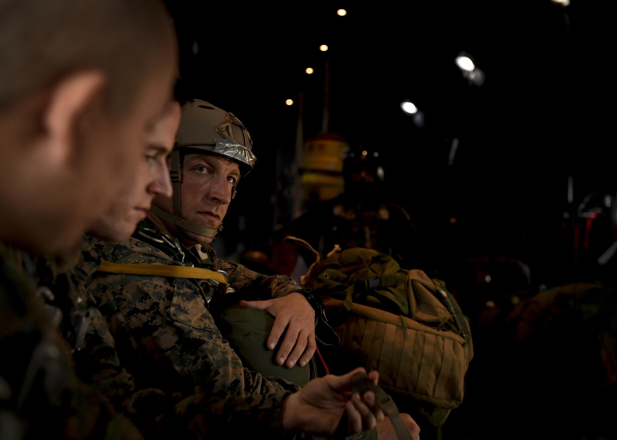 Marines with the 3rd Reconnaissance Battalion, 3rd Marine Division, III Marine Expeditionary Force, wait in a C-130 Hercules before a static line parachute drop on Jan. 11, 2017, at Yokota Air Base, Japan. The 36th Airlift Squadron provided airlift supports to U.S. Marine Corp’s weeklong jump training. (U.S. Air Force photo by Airman 1st Class Donald Hudson)