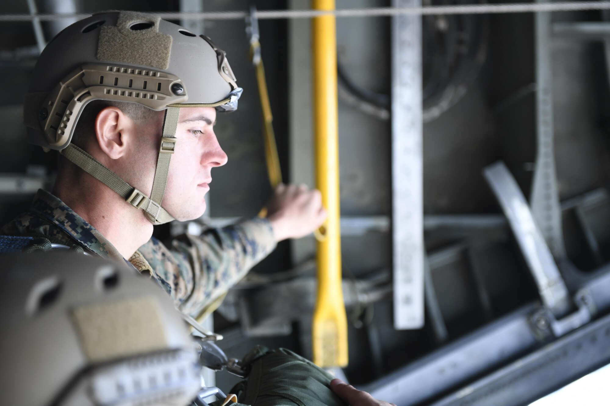 A Marine with the 3rd Reconnaissance Battalion, 3rd Marine Division, III Marine Expeditionary Force, waits on the edge of open C-130 Hercules cargo door for signal to jump during a static line parachute drop on Jan. 11, 2017, at Yokota Air Base, Japan. The 36th Airlift Squadron provided airlift supports to U.S. Marine Corp’s weeklong jump training. (U.S. Air Force photo by Airman 1st Class Donald Hudson)
