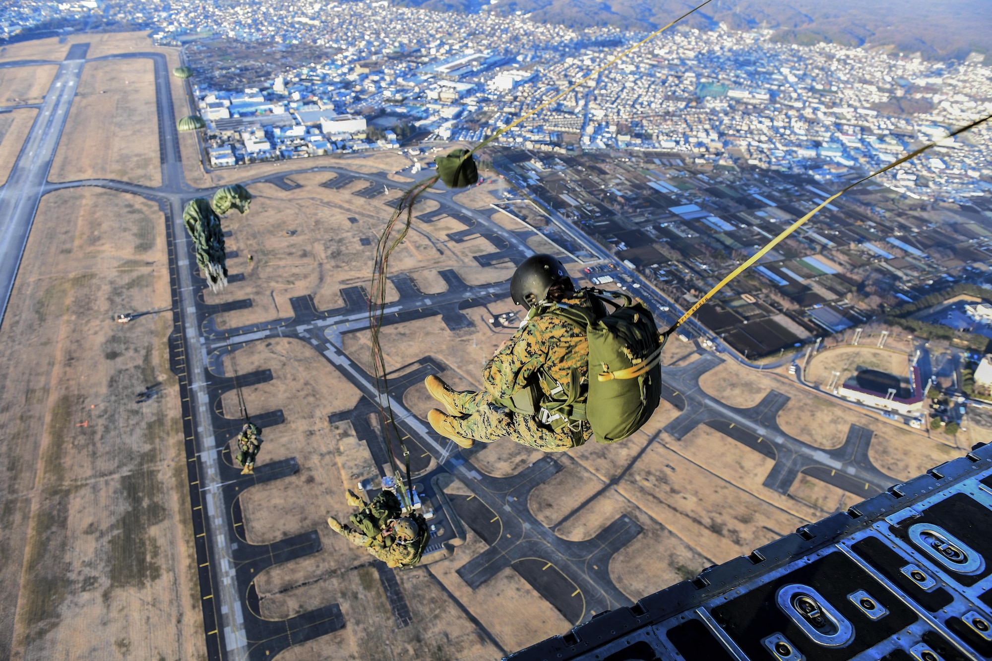Marines with the 3rd Reconnaissance Battalion, 3rd Marine Division, III Marine Expeditionary Force, perform a static line parachute jump on Jan. 11, 2017, at Yokota Air Base, Japan. The 36th Airlift Squadron provided airlift supports to U.S. Marine Corp’s weeklong jump training. (U.S. Air Force photo by Airman 1st Class Donald Hudson)