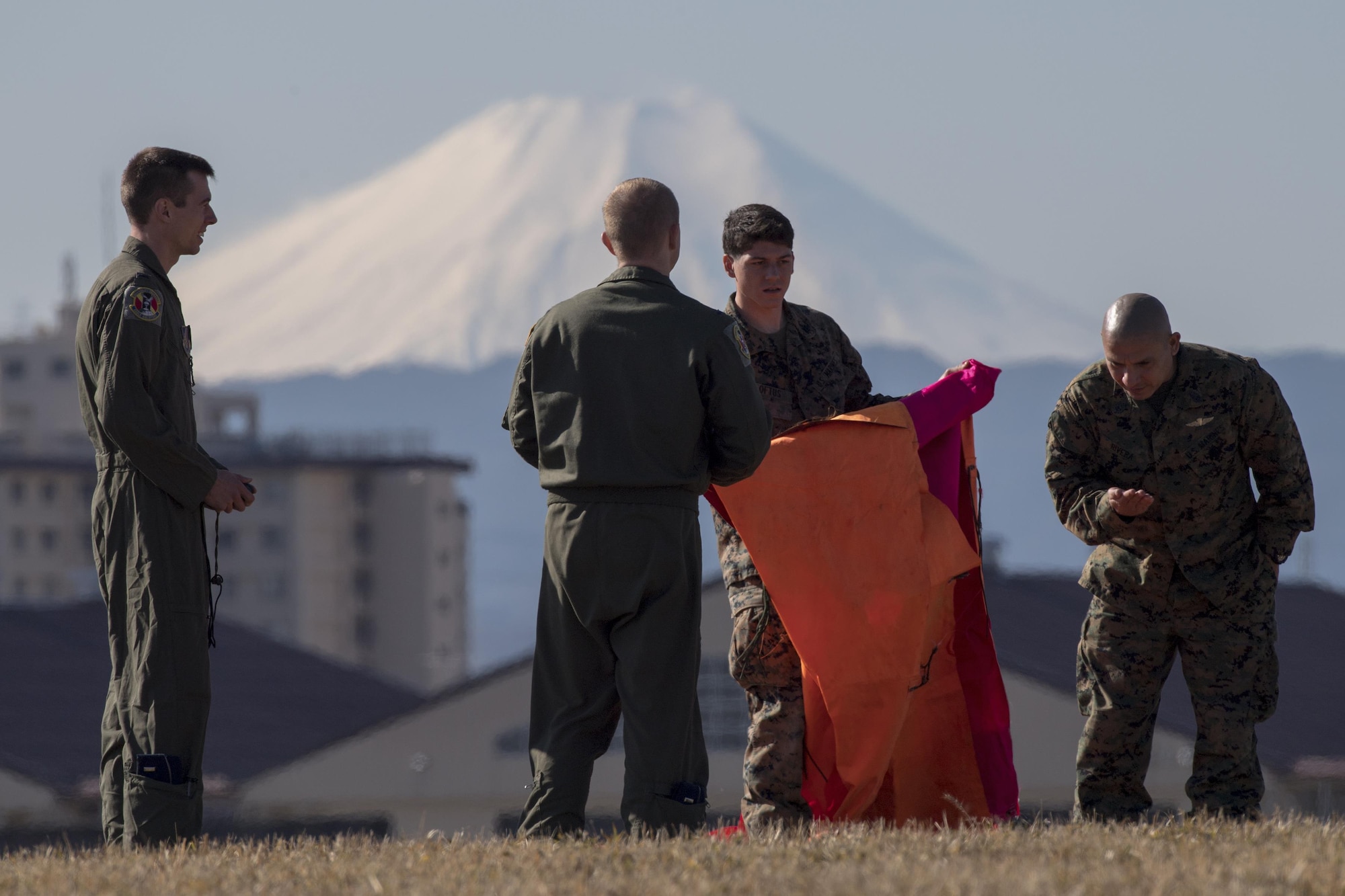 Airmen with the 36th Airlift Squadron and Marines with the 3rd Reconnaissance Battalion, 3rd Marine Division, III Marine Expeditionary Force set up an angle marker at Yokota Air Base, Japan, Jan. 10, 2017. III MEF Marines conducted weeklong jump training from an Air Force C-130 Hercules, assigned to the 36 AS. The training not only allowed the Marines to practice jumping, but it also allowed the Yokota aircrews to practice flight tactics and timed-package drops. (U.S. Air Force photo by Yasuo Osakabe/Released) 