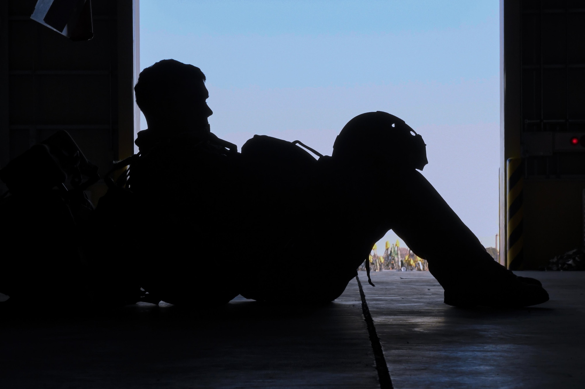 A Marine with the 3rd Reconnaissance Battalion, 3rd Marine Division, III Marine Expeditionary Force, waits to have equipment checked in preparation for a static line parachute drop on Jan. 11, 2017, at Yokota Air Base, Japan. The Marine unit spent the week working on their parachute qualifications practicing static line and high-altitude, low-opening jumps. (U.S. Air Force photo by Airman 1st Class Donald Hudson)
