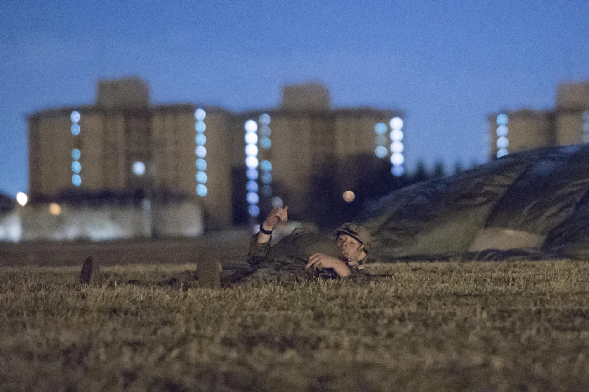 A U.S. Marine form the 3rd Reconnaissance Battalion, 3rd Marine Division, III Marine Expeditionary Force lands to the drop zone at Yokota Air Base, Japan, Jan. 11, 2017, during Jump Week. The training not only allowed the Marines to practice jumping, but it also allowed the Yokota aircrews to practice flight tactics and timed-package drops. (U.S. Air Force photo by Yasuo Osakabe/Released)  