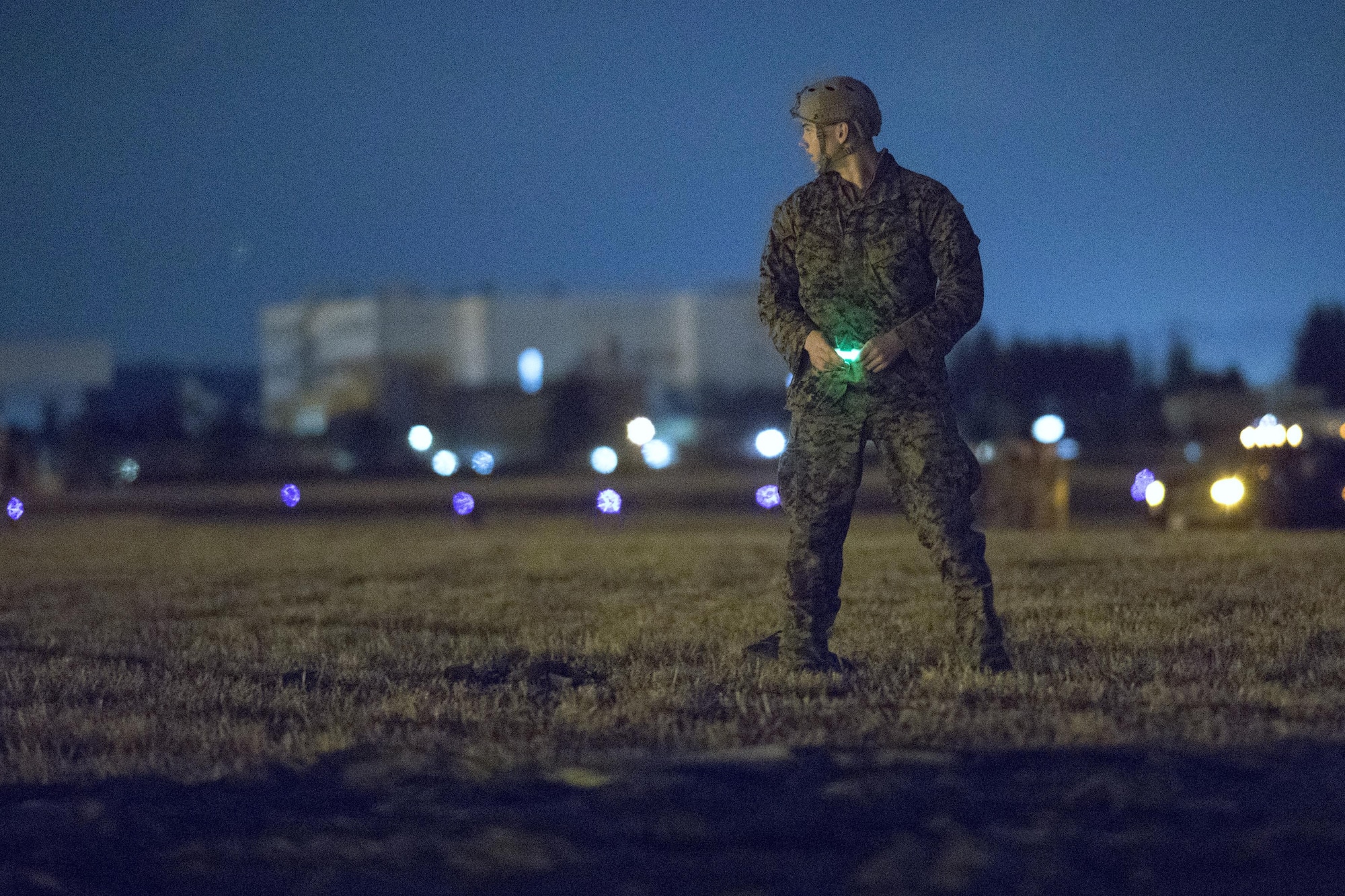A U.S. Marine form the 3rd Reconnaissance Battalion, 3rd Marine Division, III Marine Expeditionary Force lands to the drop zone at Yokota Air Base, Japan, Jan. 11, 2017, during Jump Week. The training not only allowed the Marines to practice jumping, but it also allowed the Yokota aircrews to practice flight tactics and timed-package drops. (U.S. Air Force photo by Yasuo Osakabe/Released)  