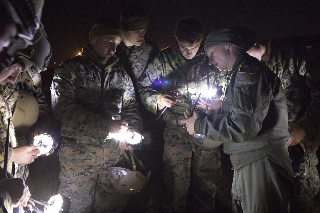 1st Lt. John Adams, right,  36th Airlift Squadron C-130 Hercules navigator, shows Marines from the 3rd Reconnaissance Battalion, 3rd Marine Division, III Marine Expeditionary Force how to operate drop zone indicator lights at Yokota Air Base, Japan, Jan. 11, 2017, during Jump week. III MEF Marines conducted weeklong jump training from a U.S. Air Force C-130H, assigned to the 36 AS. The training not only allowed the Marines to practice jumping, but it also allowed the Yokota aircrews to practice flight tactics and time-package drops. (U.S. Air Force photo by Yasuo Osakabe/Released)