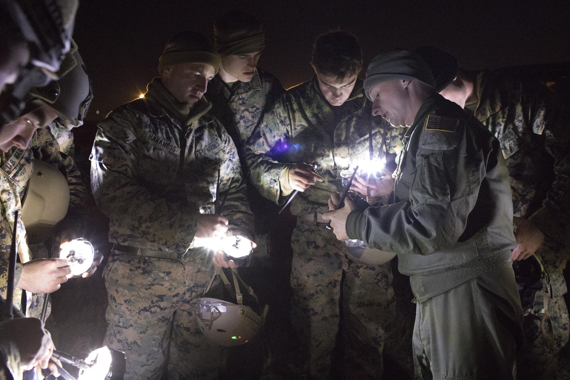 1st Lt. John Adams, right,  36th Airlift Squadron C-130 Hercules navigator, shows Marines from the 3rd Reconnaissance Battalion, 3rd Marine Division, III Marine Expeditionary Force how to operate drop zone indicator lights at Yokota Air Base, Japan, Jan. 11, 2017, during Jump week. III MEF Marines conducted weeklong jump training from a U.S. Air Force C-130H, assigned to the 36 AS. The training not only allowed the Marines to practice jumping, but it also allowed the Yokota aircrews to practice flight tactics and time-package drops. (U.S. Air Force photo by Yasuo Osakabe/Released)