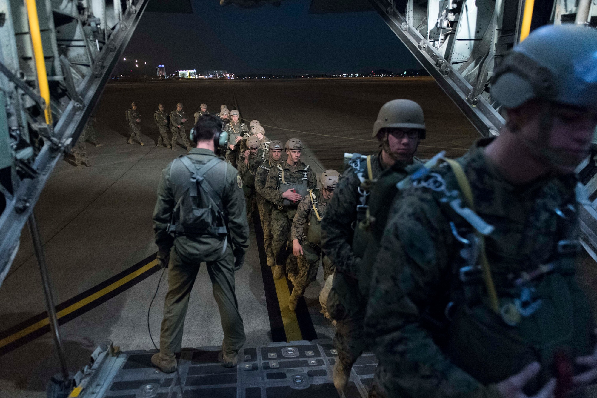 U.S. Marines from the 3rd Reconnaissance Battalion, 3rd Marine Division, III Marine Expeditionary Force board a U.S. Air Force C-130 Hercules during jump week at Yokota Air Base, Japan, Jan. 11, 2017. The 36th Airlift Squadron provided airlift support to the U.S. Marine Corp’s week-long jump training. (U.S. Air Force photo by Staff Sgt. Michael Washburn/Released) 