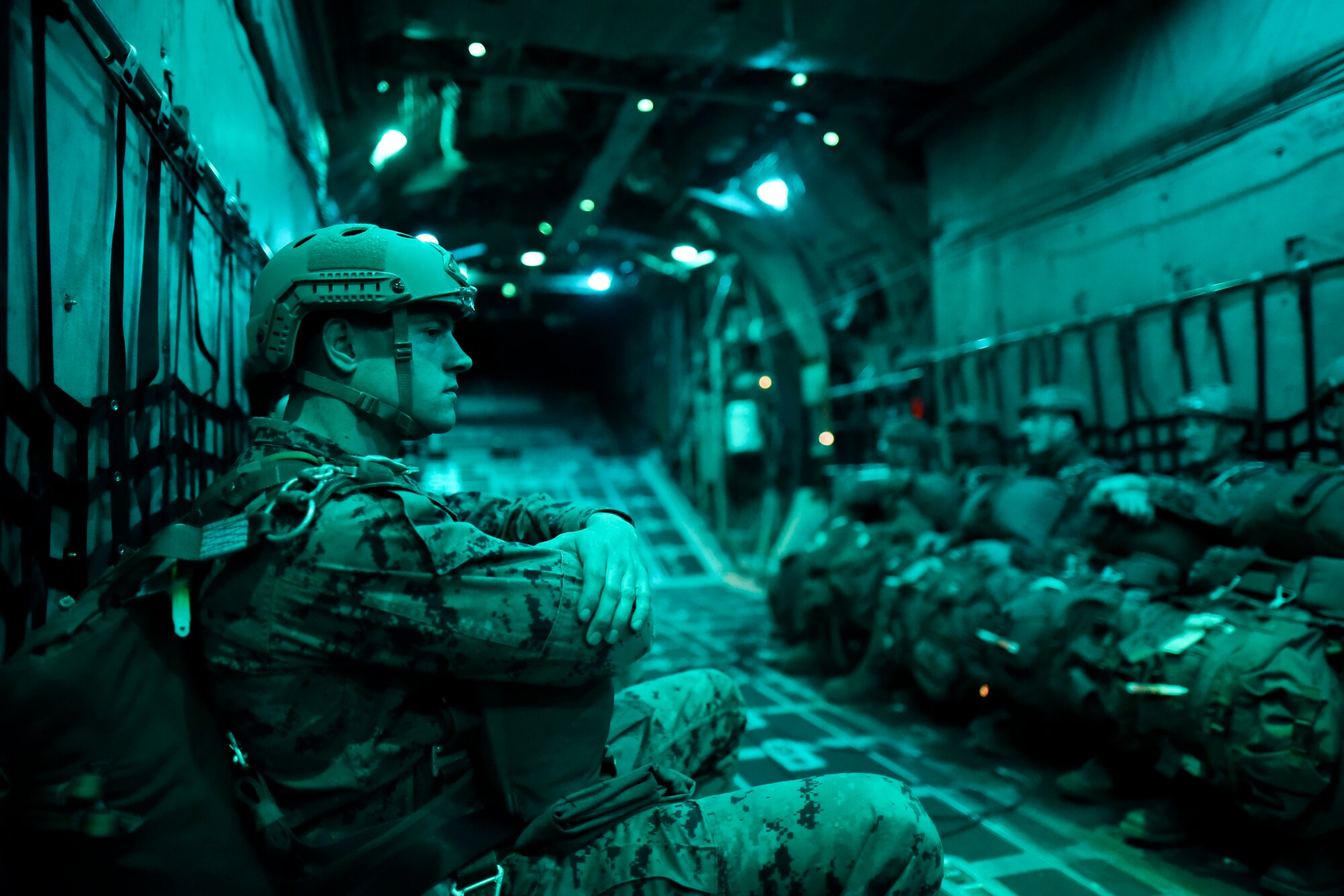 A U.S. Marine from the 3rd Reconnaissance Battalion, 3rd Marine Division, III Marine Expeditionary Force sits in a U.S. Air Force C-130 Hercules during jump week at Yokota Air Base, Japan, Jan. 11, 2017. The 36th Airlift Squadron provided airlift support to the Marine’s week-long jump training. (U.S. Air Force photo by Staff Sgt. Michael Washburn/Released)