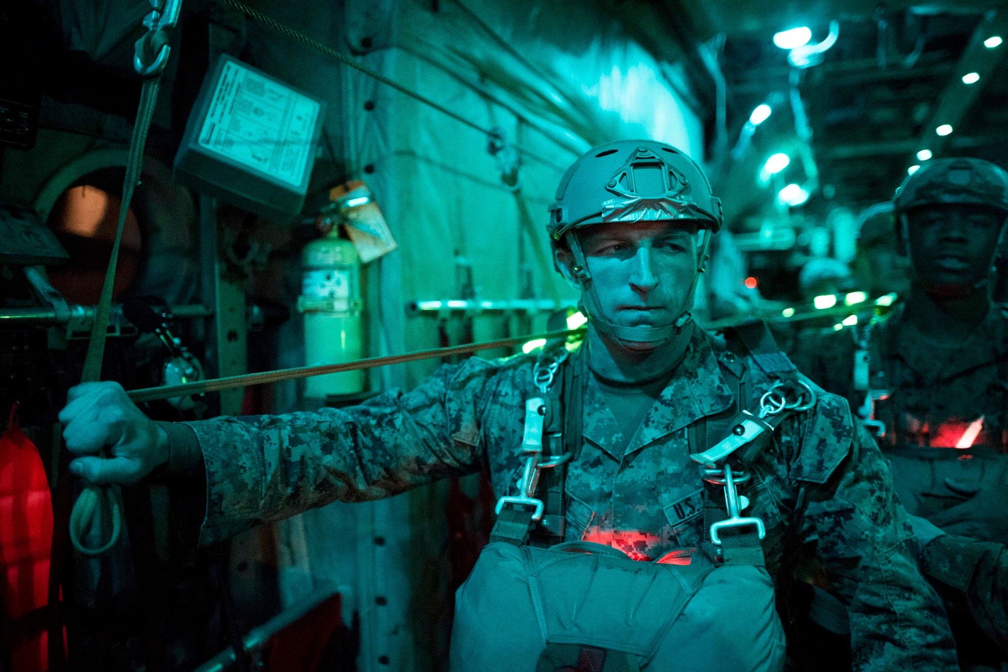 A U.S. Marine from the 3rd Reconnaissance Battalion, 3rd Marine Division, III Marine Expeditionary Force waits for his opportunity to jump from a U.S. Air Force C-130 Hercules during jump week at Yokota Air Base, Japan, Jan. 11, 2017. The training not only allowed the Marines to practice jumping, but it also allowed the Yokota aircrews to practice flight tactics and timed-package drops. (U.S. Air Force photo by Staff Sgt. Michael Washburn/Released)