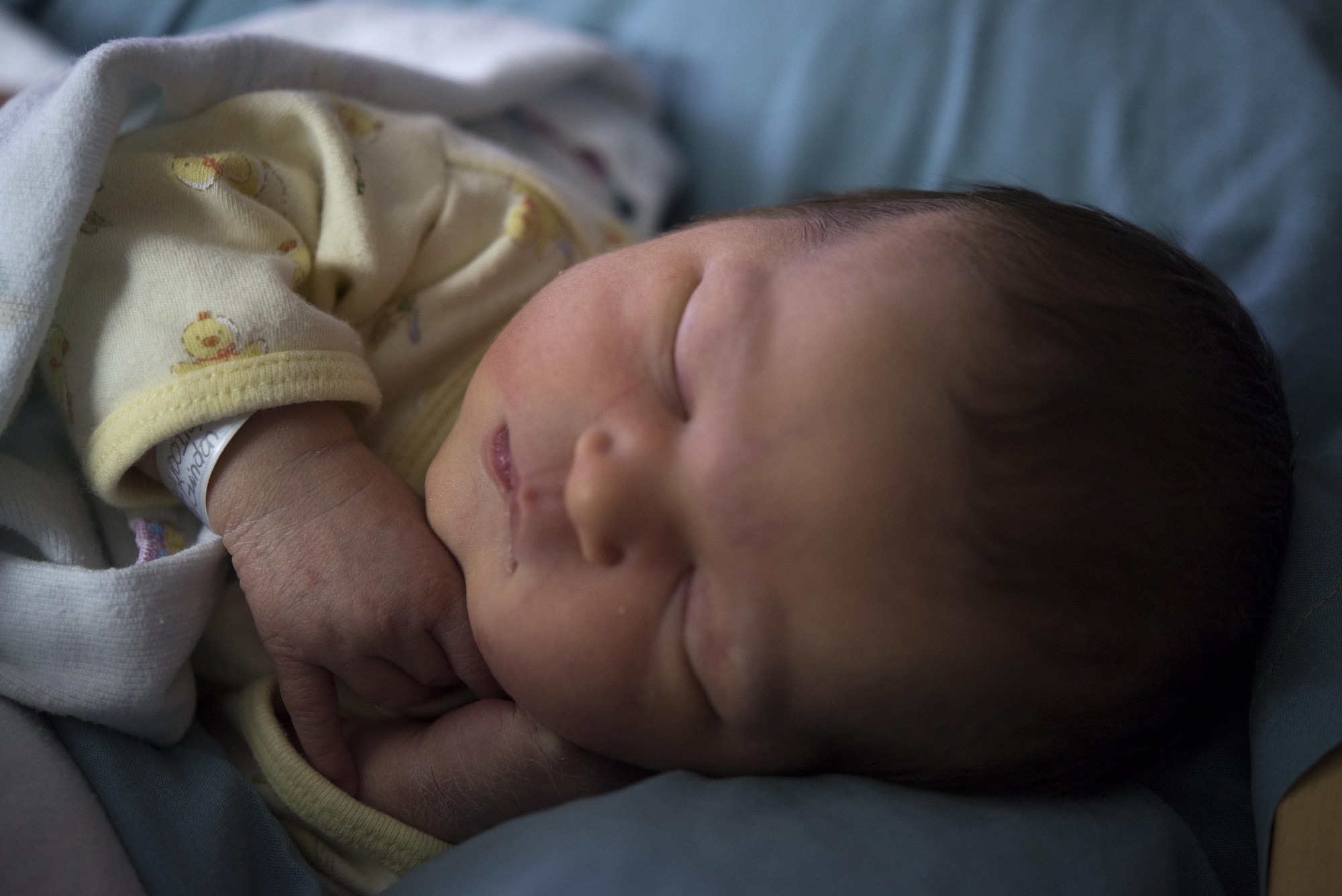 Beatrice M. Beaudoin, first baby born in the New Year on base, sleeps in her mother’s arms Jan. 8, 2017, at Yokota Air Base, Japan. Beatrice was one of four babies born on this date in Yokota. (U.S. Air Force photo by Airman 1st Class Juan Torres)