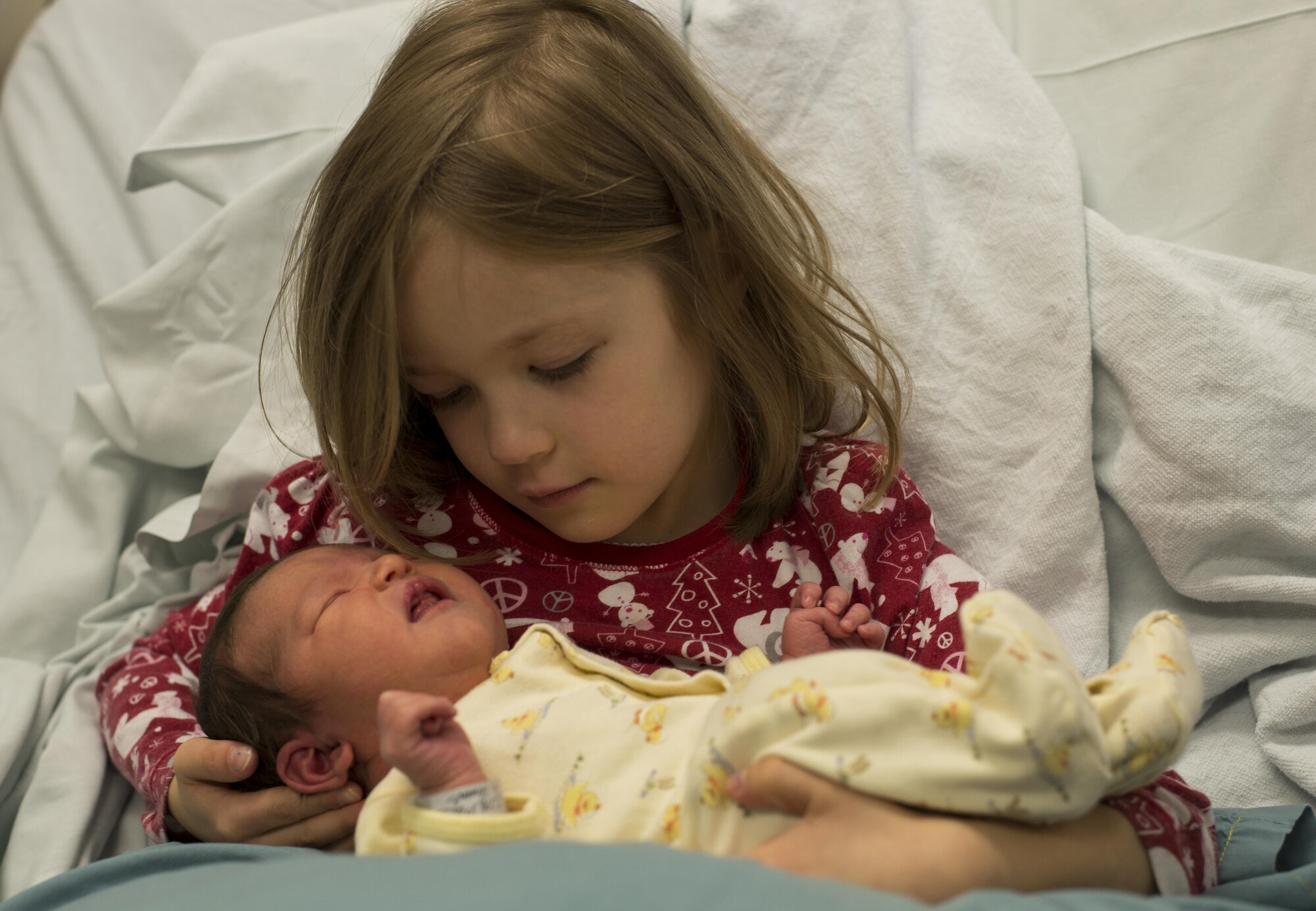 Charlotte N. Beaudoin, holds her newborn sister, Beatrice M. Beaudoin, first baby born in the New Year on base, in her arms Jan. 8, 2017, at Yokota Air Base, Japan. Beatrice was one of four babies born on this date in Yokota. (U.S. Air Force photo by Airman 1st Class Juan Torres)