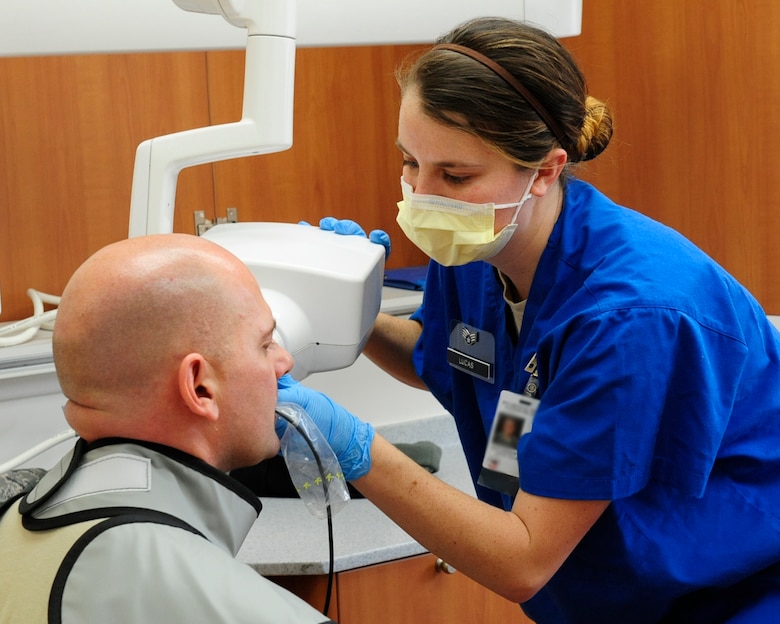 Senior Airman Amber Lucas, 8th Medical Operations Squadron dental technician, performs a dental X-ray on a patient during an annual exam at Kunsan Air Base, Republic of Korea, Jan. 4, 2017. The X-ray helps dentists identify tooth decay and bone health. (U.S. Air Force photo by Staff Sgt. Chelsea Browning/Released)  