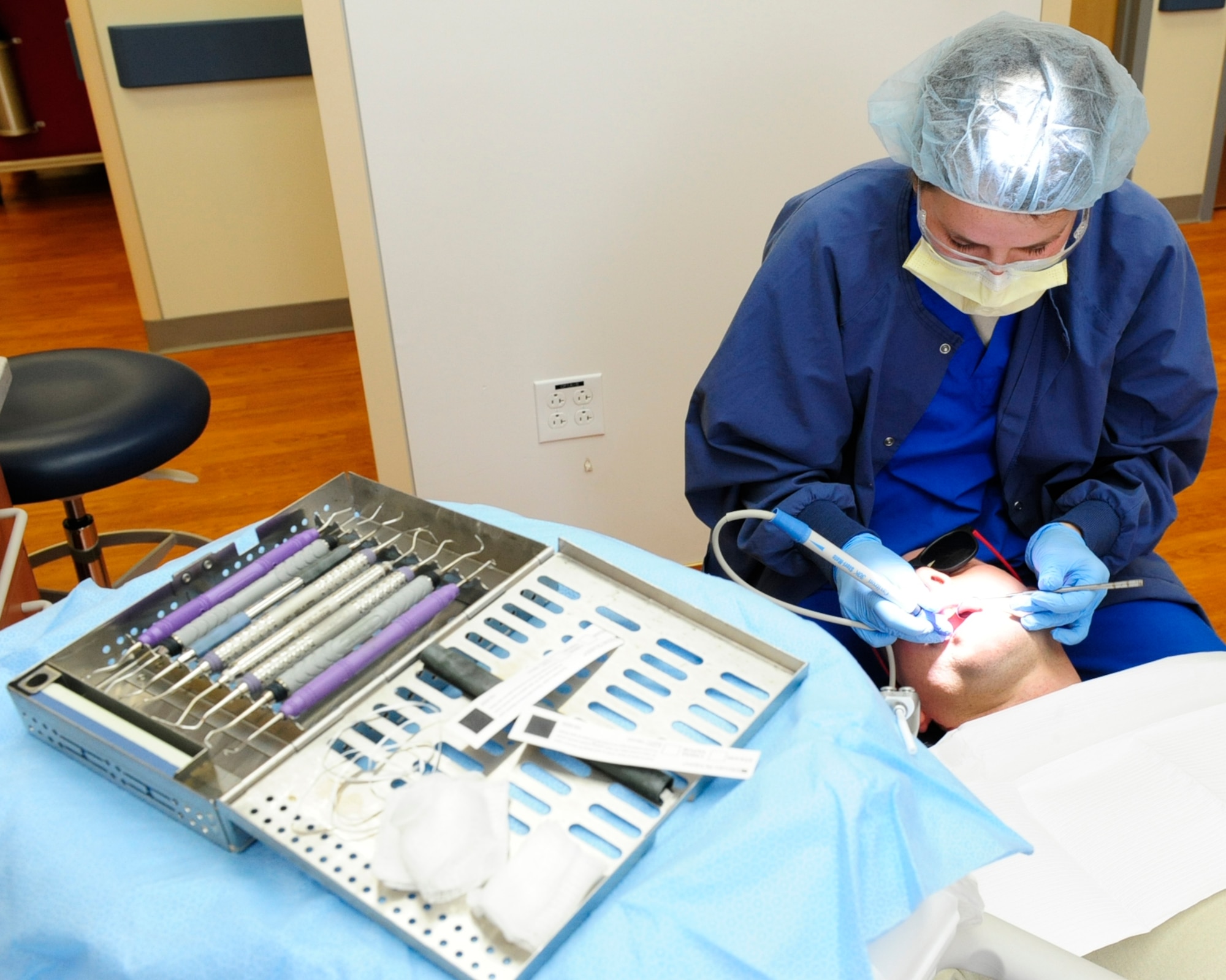 Senior Airman Amber Lucas, 8th Medical Operations Squadron dental technician, performs a cleaning on a patient during an annual exam at Kunsan Air Base, Republic of Korea, Jan. 4, 2017. Dental technicians train on a wide range of tasks, which include everything from scheduling and confirming patient appointments, to taking dental X-rays, to preparing patients for other dental procedures. (U.S. Air Force photo by Staff Sgt. Chelsea Browning/Released)
