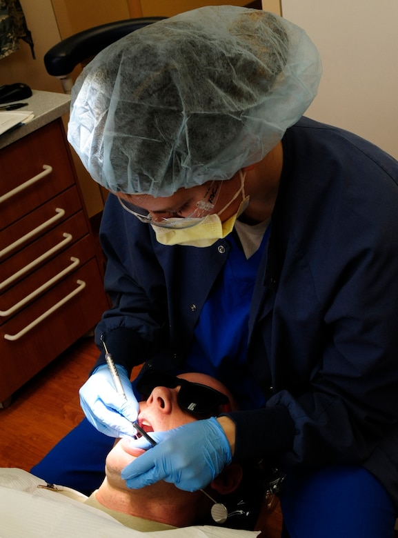 Senior Airman Amber Lucas, 8th Medical Operations Squadron dental technician, performs a cleaning on a patient during an annual exam at Kunsan Air Base, Republic of Korea, Jan. 4, 2017. Dental technicians train on a wide range of tasks, which include everything from scheduling and confirming patient appointments, to taking dental X-rays, to preparing patients for other dental procedures. (U.S. Air Force photo by Staff Sgt. Chelsea Browning/Released)