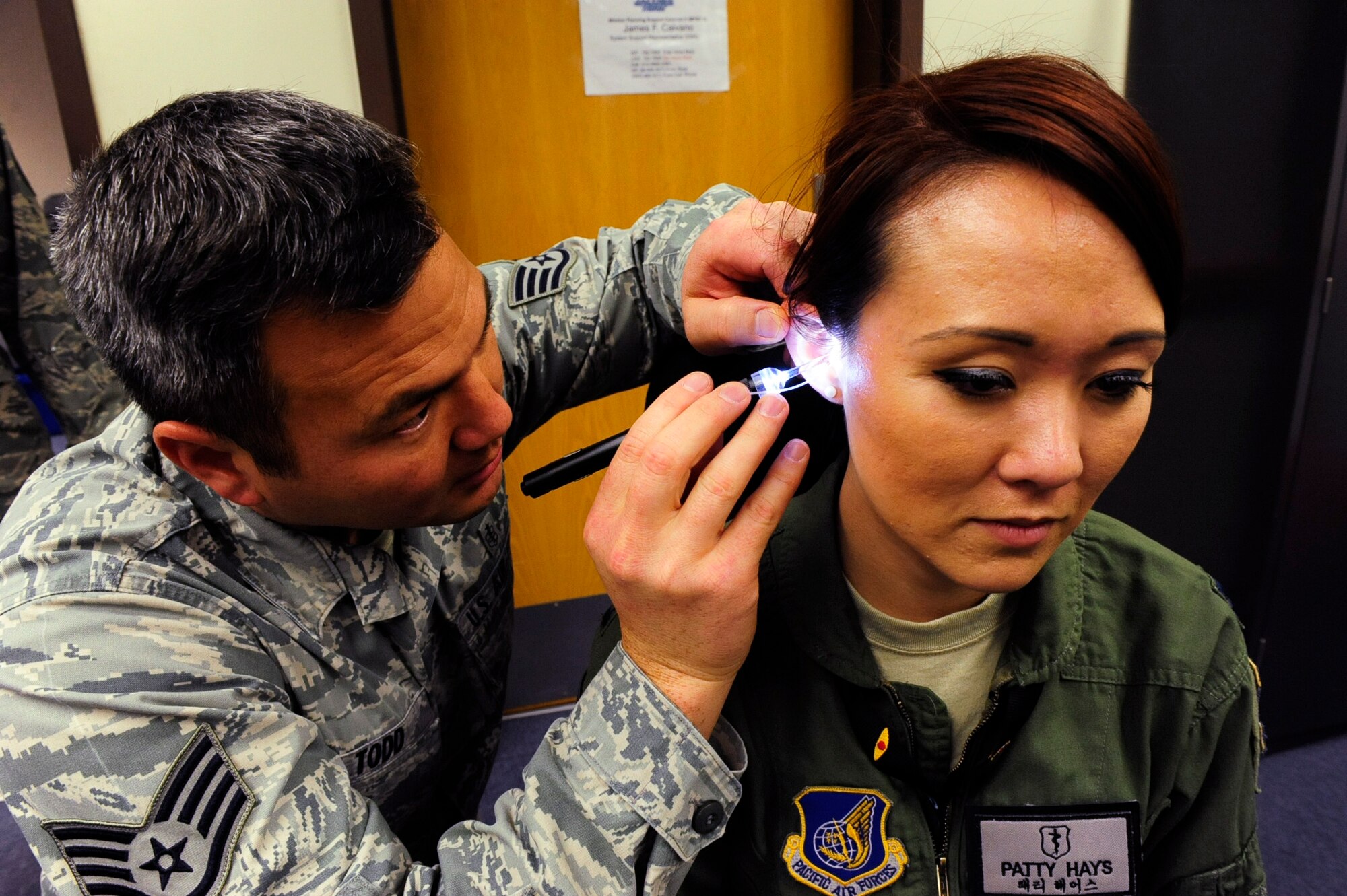 Staff Sgt. Edward Todd, 8th Medical Operations Squadron dental laboratory technician, inserts a tube into the ear of Capt. Patricia Hays, 8th Medical Operations Squadron aerospace and operational physiologist, to make an inner-ear mold for the Attenuating Custom Communications Earpiece System at Kunsan Air Base, Republic of Korea, Jan. 9, 2017. The ACCES device will significantly reduce surrounding ambient noise that pilots hear in the cockpit and increase the efficiency of radio communications. (U.S. Air Force photo by Staff Sgt. Chelsea Browning/Released)