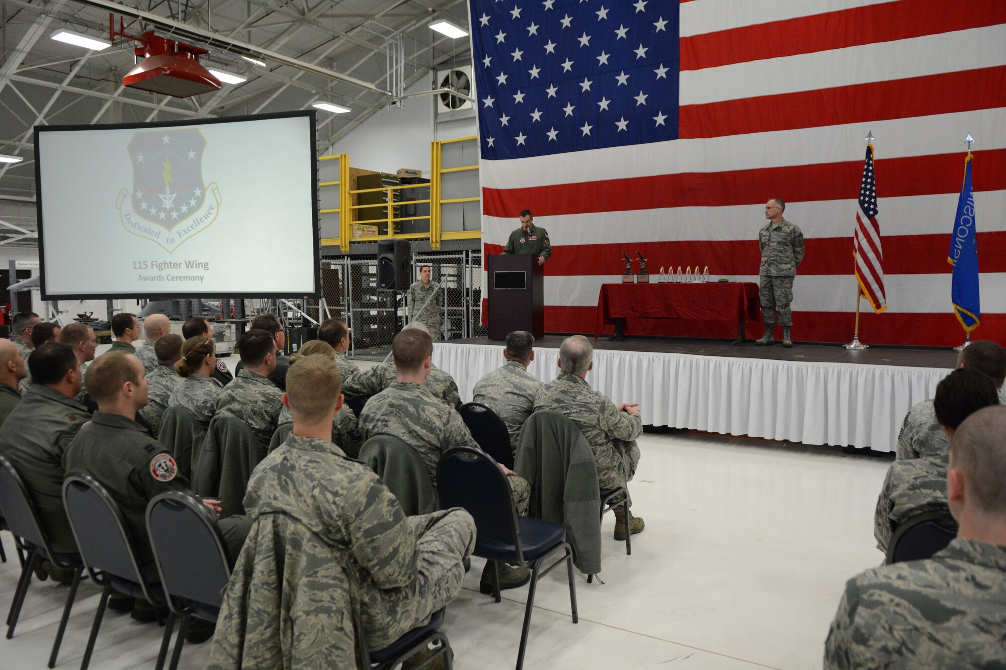 Col. Erik Peterson, 115th Fighter Wing commander, addresses Airmen from across the base at the 2016 Awards Ceremony in Hangar 406 on Jan. 7, 2017. During the ceremony, there were eight categories of awards presented, including Airman of the Year, Non-commissioned Officer of the Year and Company Grade Officer of the Year, among others. (U.S. Air National Guard photo by Staff Sgt. Kyle Russell)