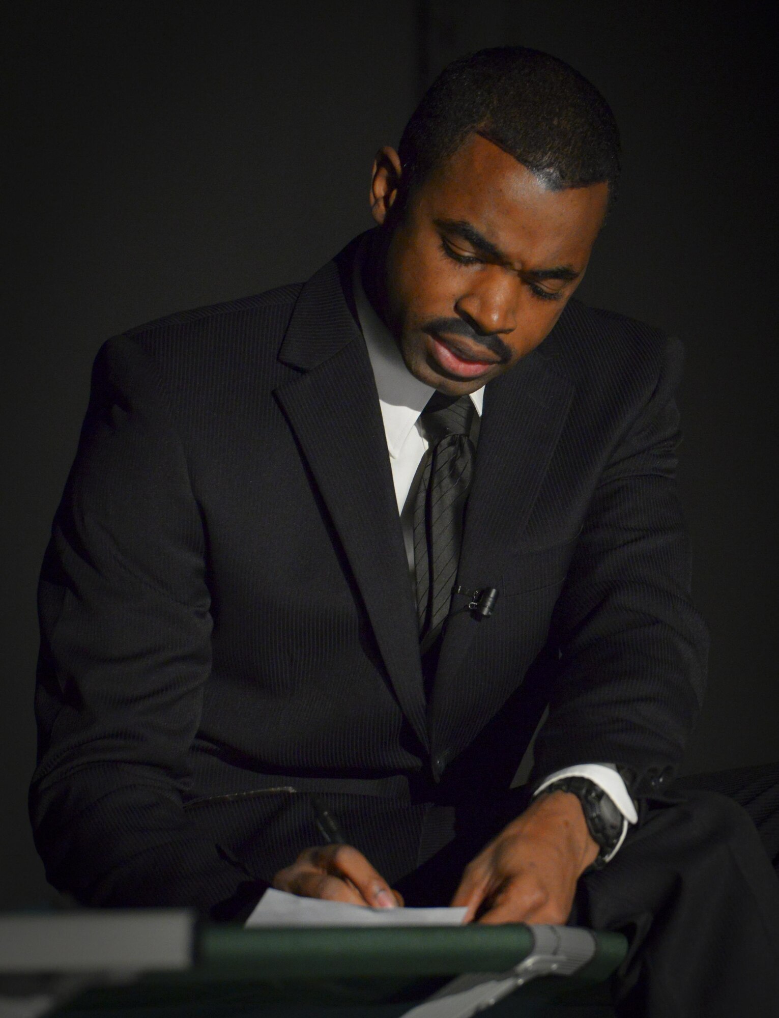 Staff Sgt. Jason Hamm, 374th Security Forces Squadron combat arms instructor, portrays Martin Luther King Jr. writing a letter from jail during “The Story of a Dream,” a play chronicling African American suffrage of the mid 1950s at Yokota Air Base, Jan. 12, 2017.  Martin Luther King Jr. was a Baptist minister and social activist who played a key role in the American civil rights movement. The values of freedom and equality which King fought for continue to be highly valued in the Air Force today.  (U.S. Air Force photo by Senior Airman Elizabeth Baker)