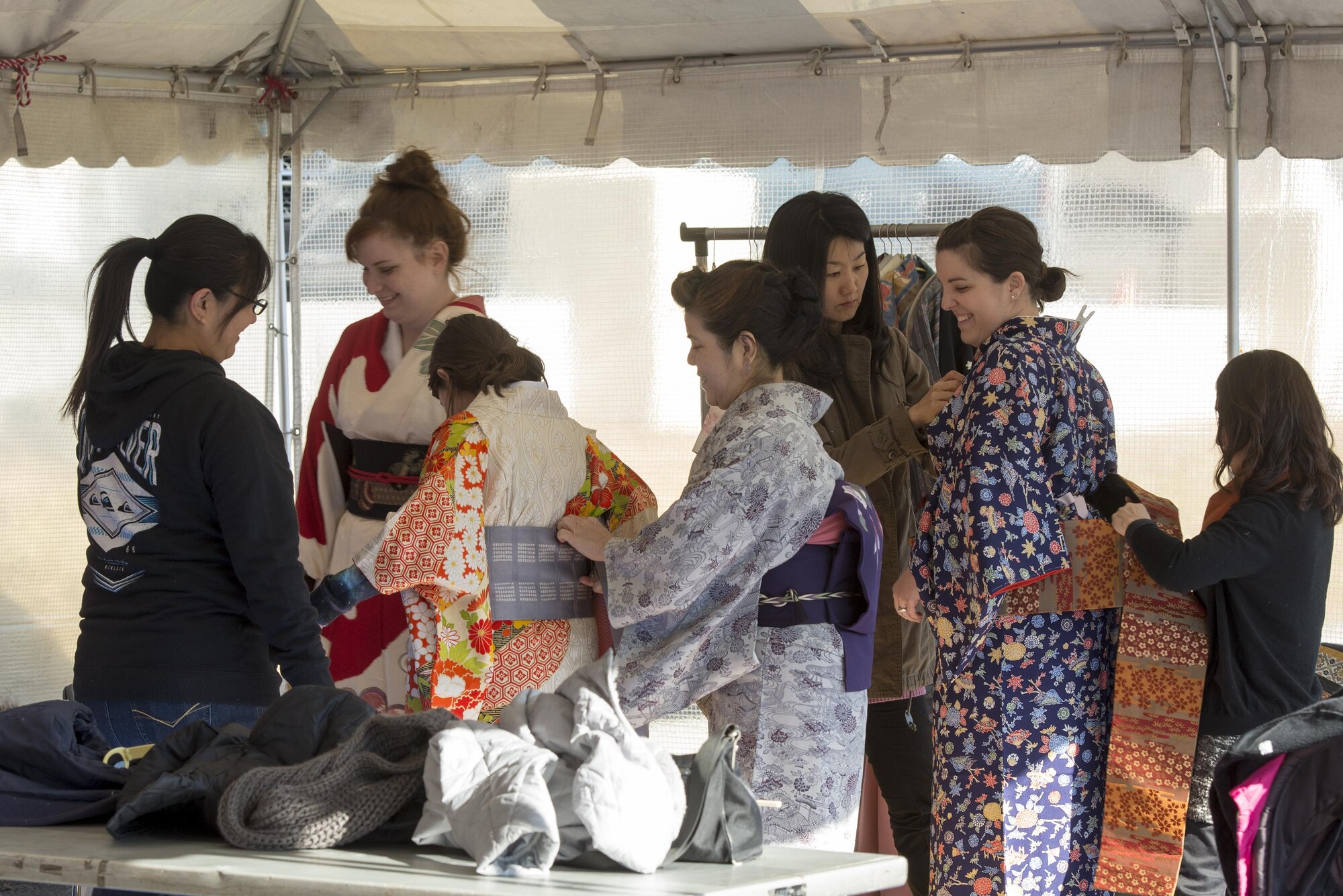 Yokota members get dressed in traditional kimonos during the Japan Culture Day event hosted by the Japanese Welfare Association at Yokota Air Base, Japan, Jan. 13, 2017. The event included traditional festival food, a performance from the Samurai Taiko Drum Team, musicians playing the koto and shamisen and tea ceremonies. (U.S. Air Force photo by Senior Airman David C. Danford)