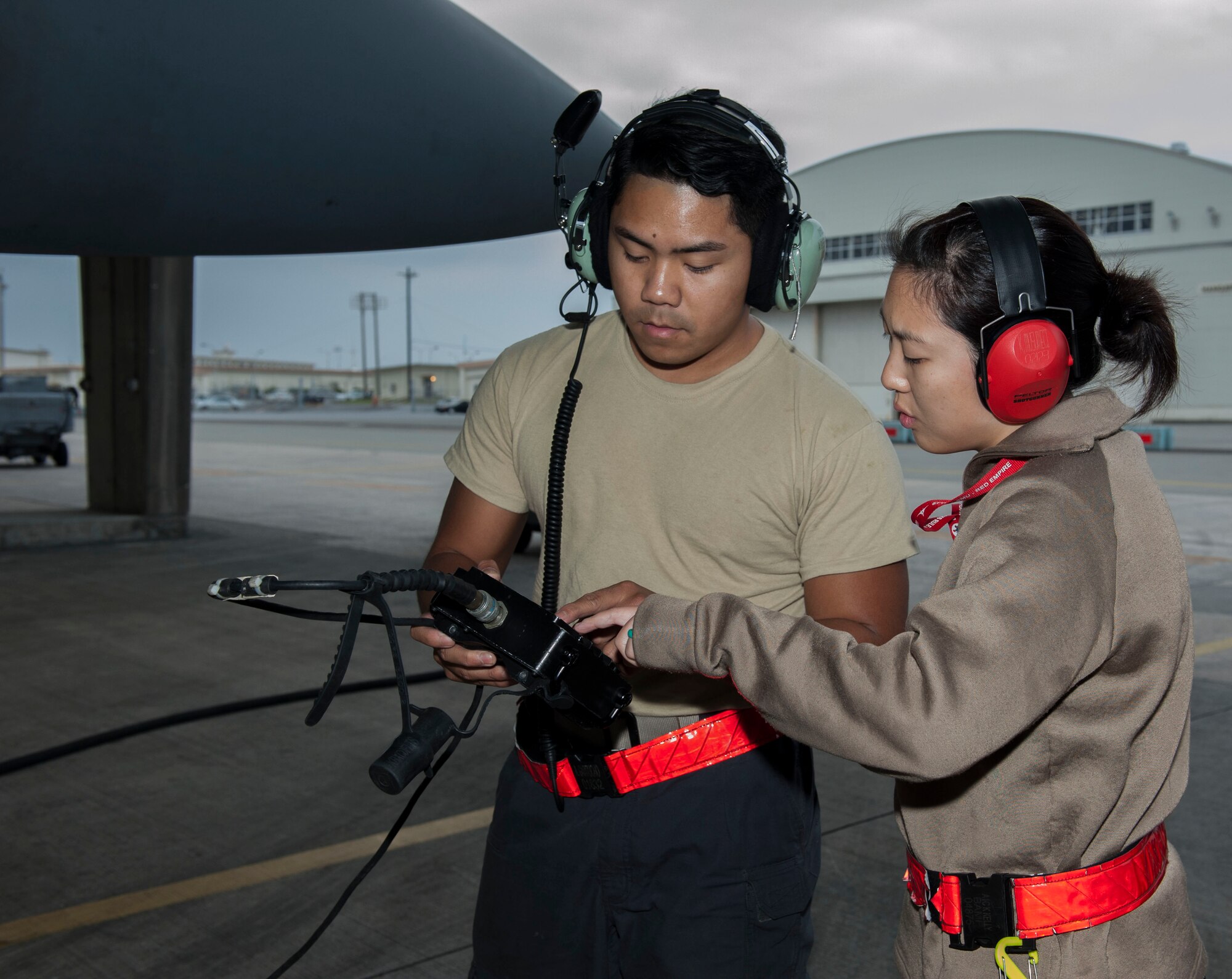 U.S. Air Force Staff Sgt. Kaleena Musumeci, 67th Aircraft Maintenance Unit avionics technician, assists Senior Airman Jason Garciadealba, 67th AMU avionics technician, with a remote control unit Jan. 10, 2017, at Kadena Air Base, Japan. The RCU identifies any problems with the avionics systems of the F-15 Eagle. (U.S. Air Force photo by Senior Airman Lynette M. Rolen/Released)