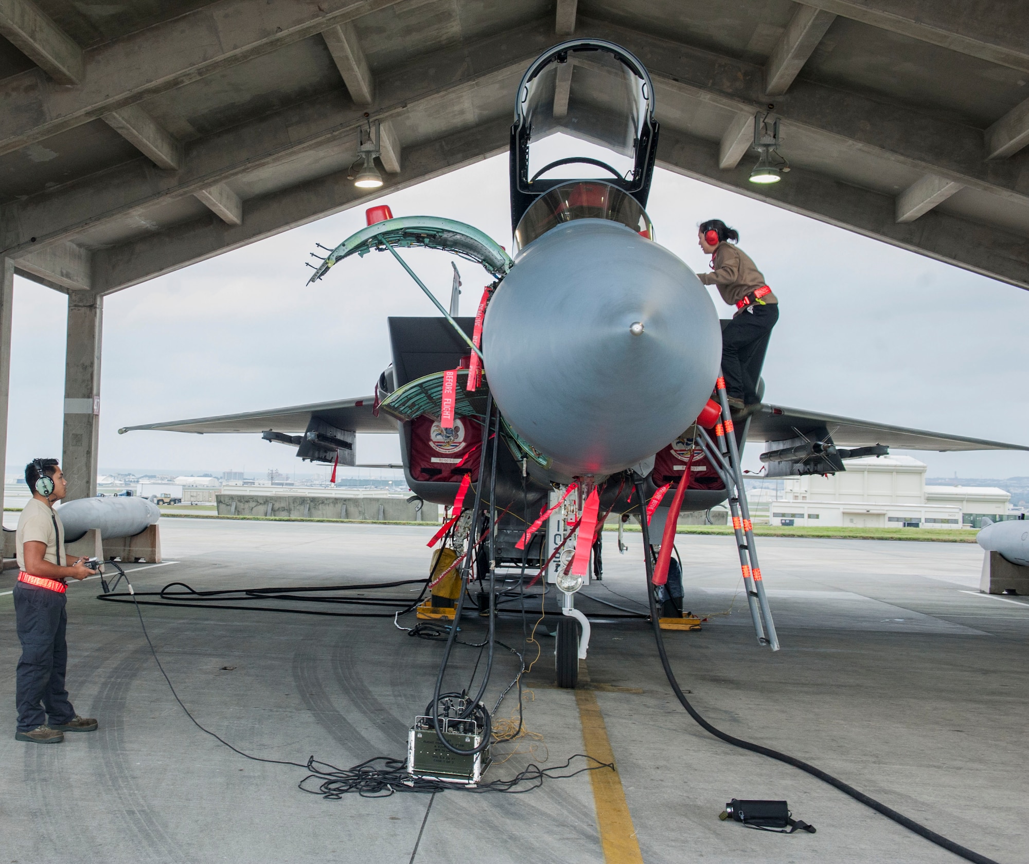 U.S. Air Force Staff Sgt. Kaleena Musumeci and Senior Airman Jason Garciadealba, 67th Aircraft Maintenance Unit avionics technicians, check avionics systems of an F-15 Eagle Jan. 10, 2017, at Kadena Air Base, Japan. Avionics technicians check and troubleshoot systems such as flight controls, communications and weapons. (U.S. Air Force photo by Senior Airman Lynette M. Rolen/Released)