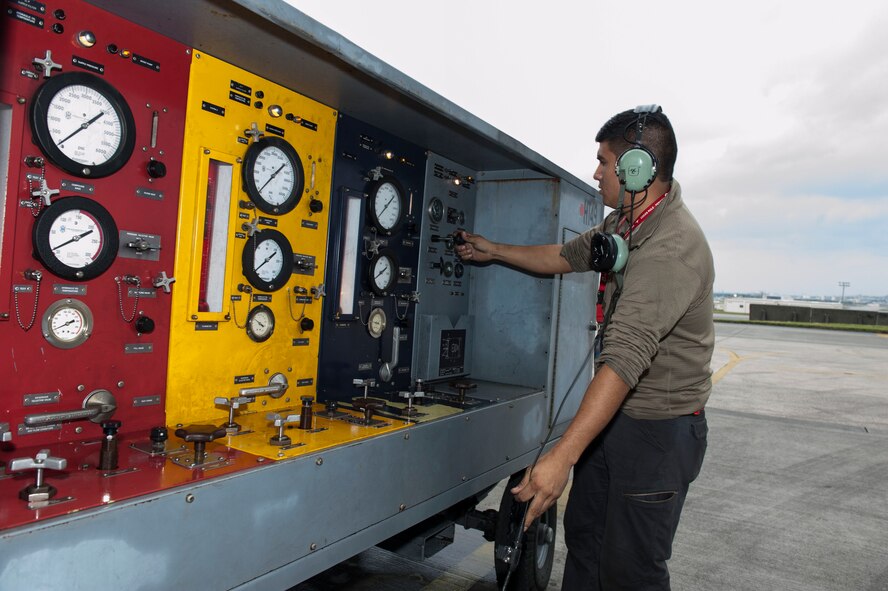 U.S. Air Force Senior Airman Adrian Garrucho, 67th Aircraft Maintenance Unit avionics technician, turns on a hydraulic test stand Jan. 10, 2016, at Kadena Air Base, Japan. The hydraulic test stand assists with running tests on an aircraft and gets hydraulics moving in the jet. (U.S. Air Force photo by Senior Airman Lynette M. Rolen/Released)