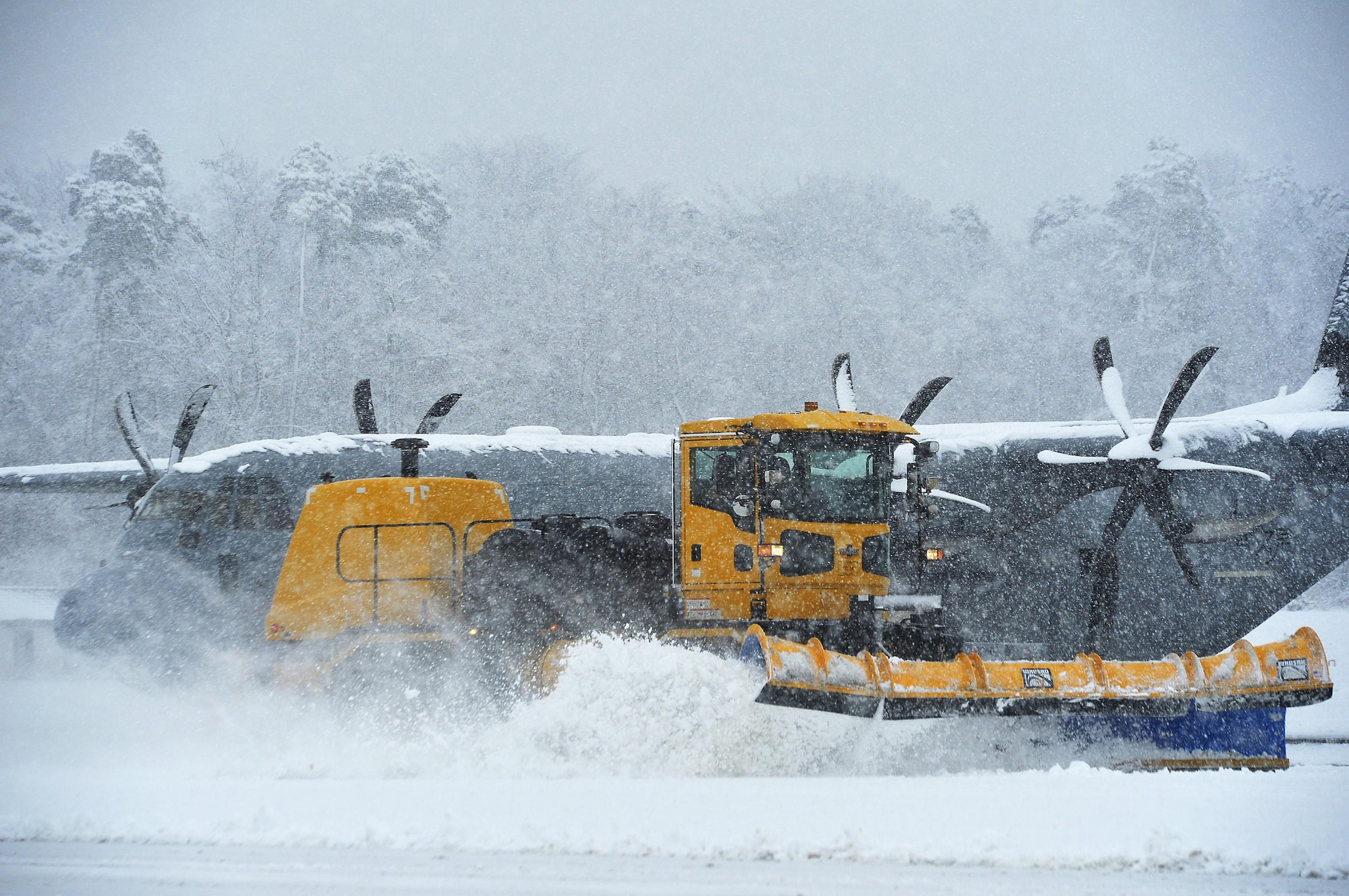 A snow plow removes snow on the flightline at Ramstein Air Base, Germany, Jan. 10, 2017. Snow removal operations commenced throughout Ramstein as continuous heavy snow persisted throughout the majority of the day. Other snow removal operations included de-icing aircraft and applying salt to roads and walkways. (U.S. Air Force photo by Airman 1st Class Joshua Magbanua)