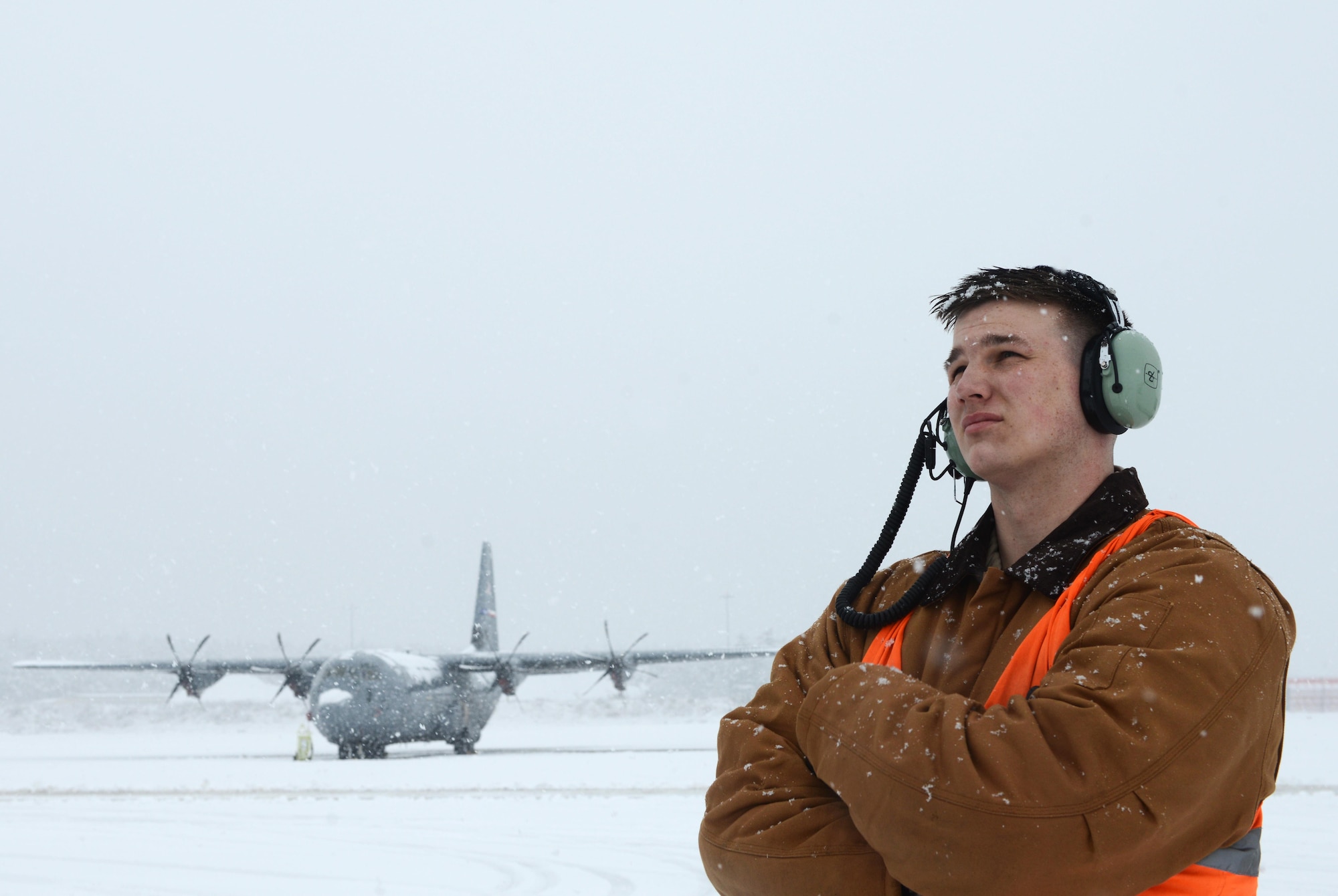 Senior Airman Damian Halpin, 86th Aircraft Maintenance Squadron crew chief, stands on the flightline as he observes de-icing operations for aircraft at Ramstein Air Base, Germany, Dec. 10, 2017. The installation conducted snow removal operations throughout the installation as continuous heavy snowfall persisted throughout the majority of the day. (U.S. Air Force photo by Airman 1st Class Joshua Magbanua)