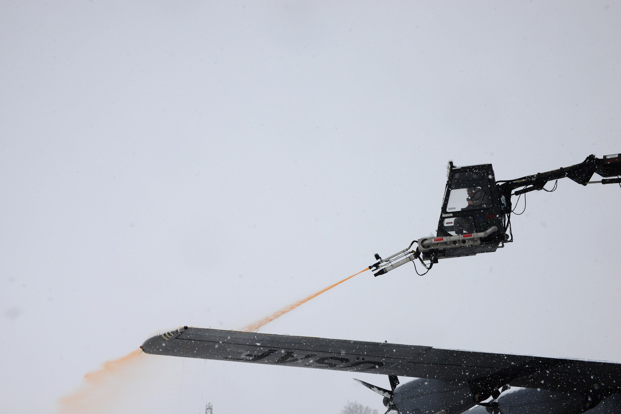 A de-icing vehicle sprays a de-icing fluid onto the wing of a C-130J Super Hercules Aircraft at Ramstein Air Base, Germany, Jan. 10, 2017. Continuous heavy snowfall prevailed throughout the majority of the day, prompting snow removal operations across the installation. The fluid helps prevent build-up of snow for a certain amount of time, especially before flight. (U.S. Air Force photo by Airman 1st Class Joshua Magbanua)