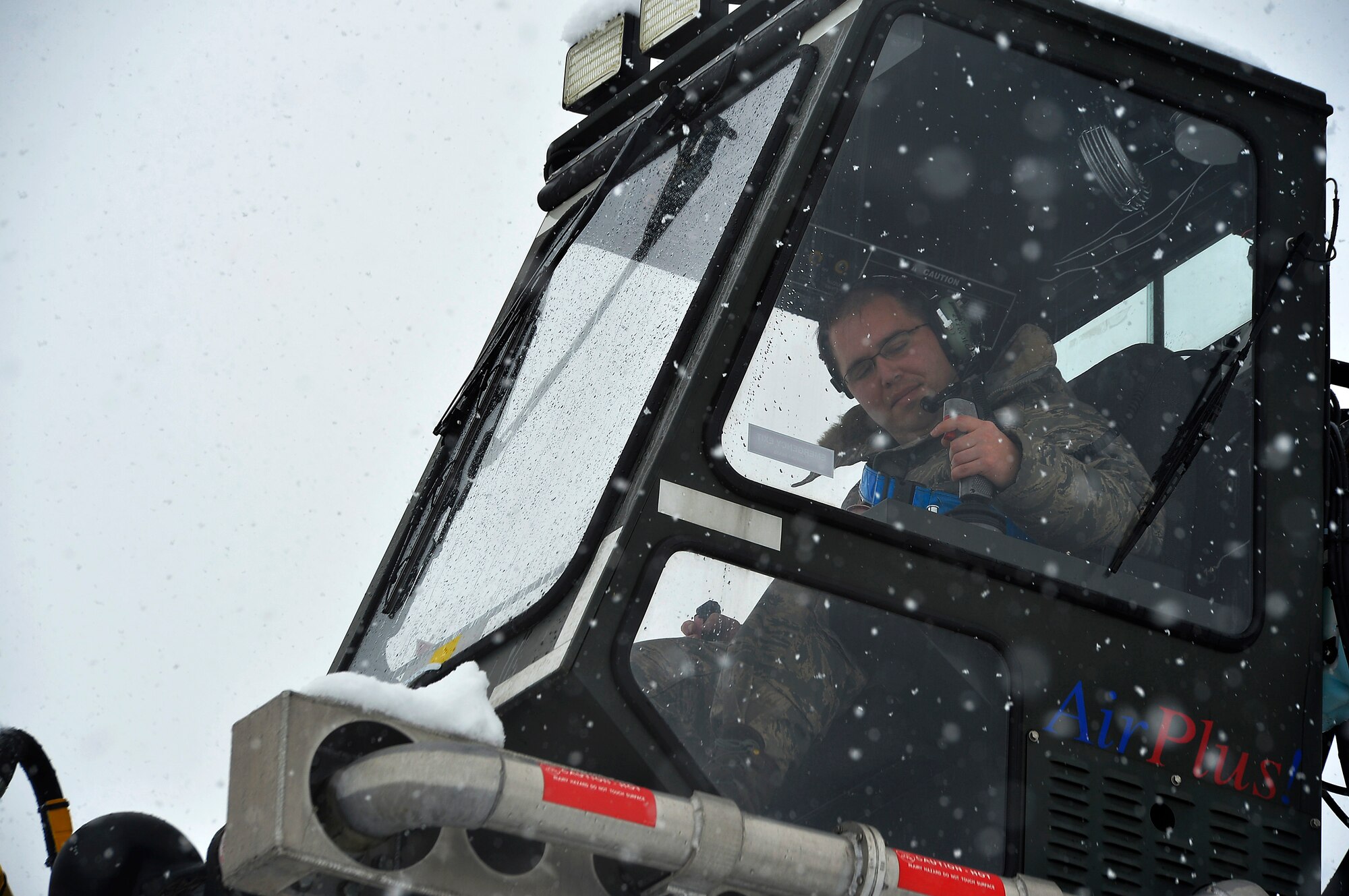Staff Sgt. Brian Leddon, 86th Aircraft Maintenance Squadron missions systems craftsman, operates a de-icing vehicle at Ramstein Air Base, Germany, Jan. 10, 2017. More than three inches of snow fell in the area, prompting snow removal operations throughout the base. The operations included plowing snow, de-icing aircraft, and applying salt on roads and walkways. (U.S. Air Force photo by Airman 1st Class Joshua Magbanua)
