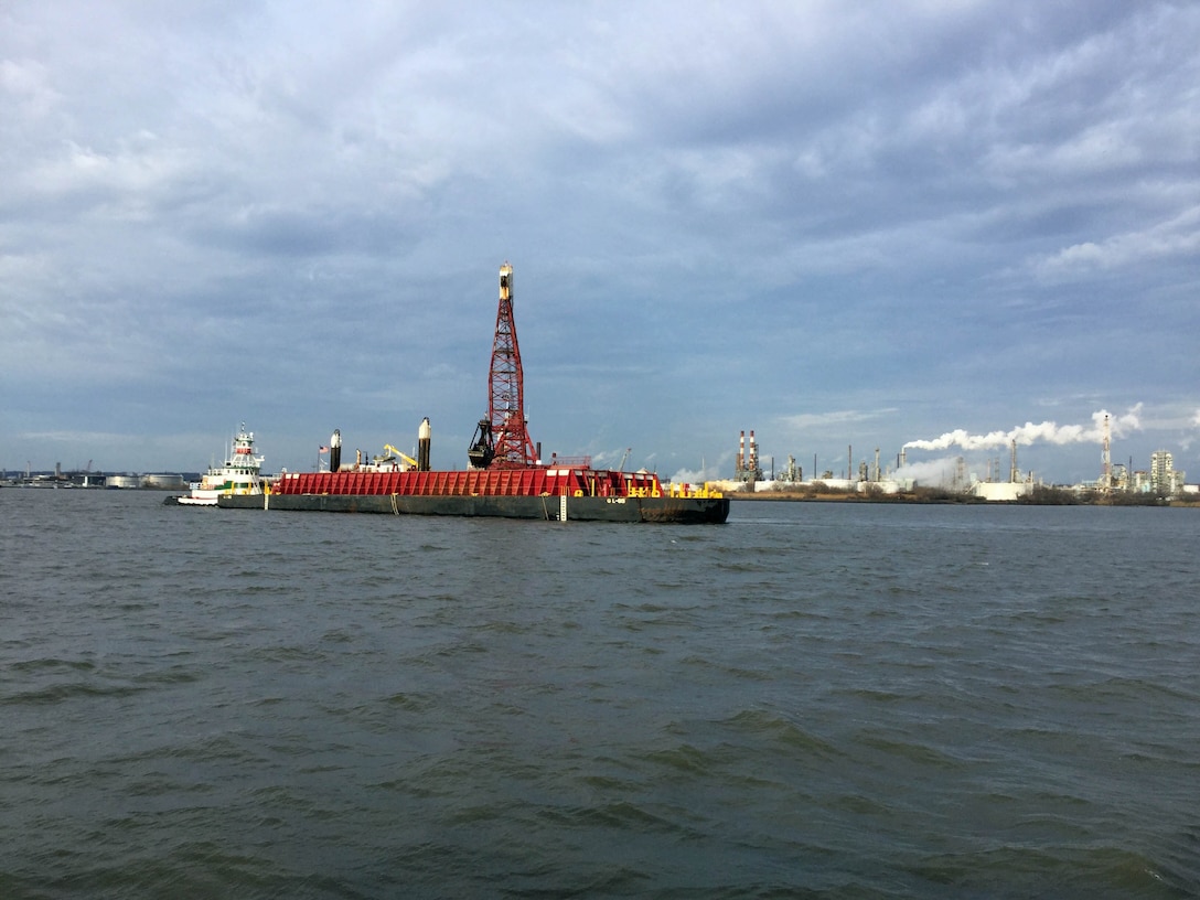 Clamshell dredge No. 54 removes rock fragments from areas where blasting operations have already been completed near Marcus Hook, PA (Sunoco refinery in background). The U.S. Army Corps of Engineers and its contractor Great Lakes Dredge & Dock Company are conducting rock blasting operations on the Delaware River. Work is a part of a project to deepen the federal channel of the river to provide for more efficient maritime transport of cargo. 